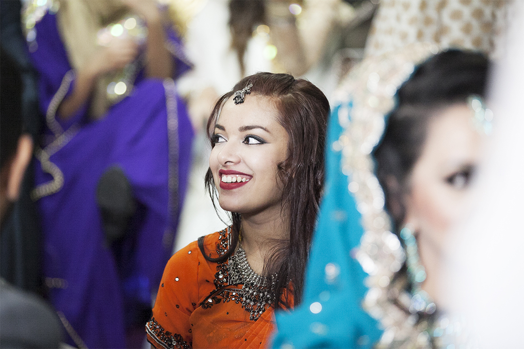 Colour and Laughter Fill the Room This part of the wedding is laid back and relaxed. Guests are laughing and joking together, eating and taking selfless of one another. Lots of brightly coloured sari's fill the room, and bring life to the event.