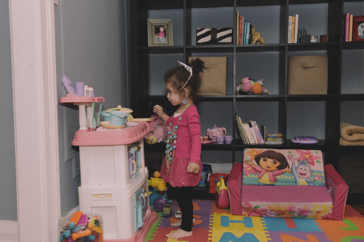 And run around she does, bouncing from her miniature Dora the Explorer couch and her bright red scoot-along train in the living room to the kitchen, where she hands her mom a pair of sparkly pink Converse low tops to help her put on, only to come back a few minutes later with a new set of sneakers she wants to wear.