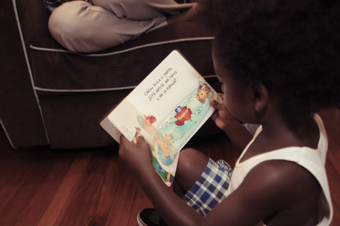 Raif reading a Caillou book in Spanish.