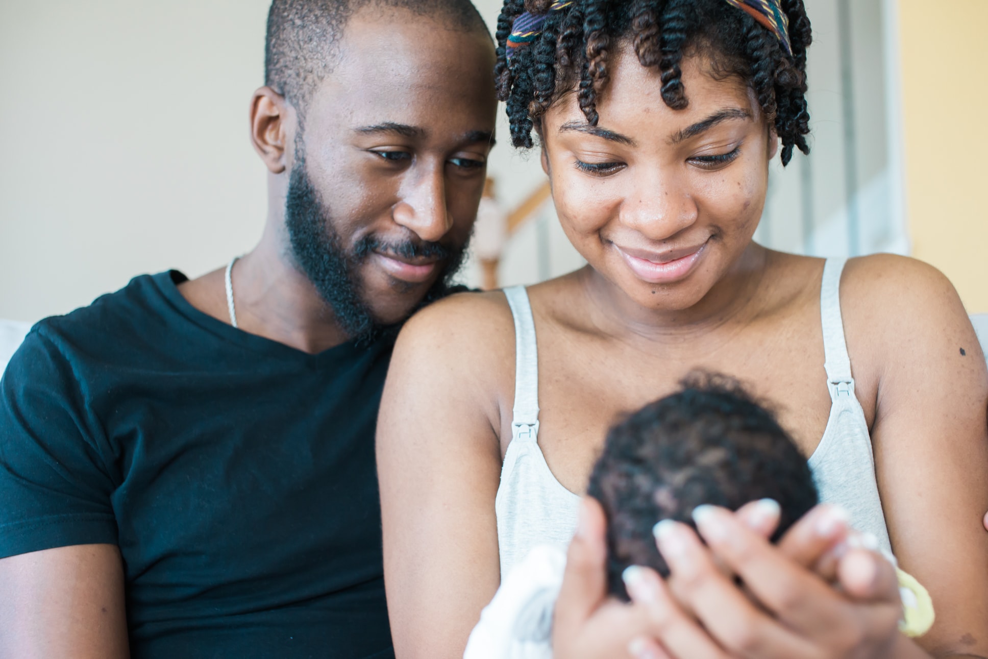 Mae Murphy and her husband Anthony II gaze at their son Anthony III. Photo credit: Sophia Barrett Studios