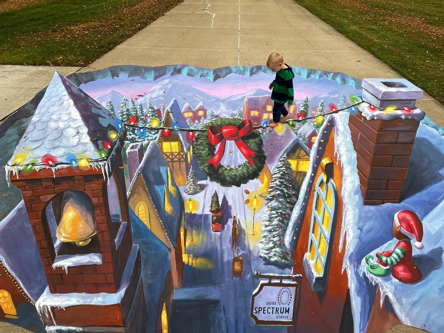 Here&rsquo;s a fun Christmas village I painted on canvas with @chriscarlsonart for @irvinespectrumcenter!  Then I was able to convince a very cute boy to walk across the light strand 😀. Happy Holidays everyone!  See you in the New Year!