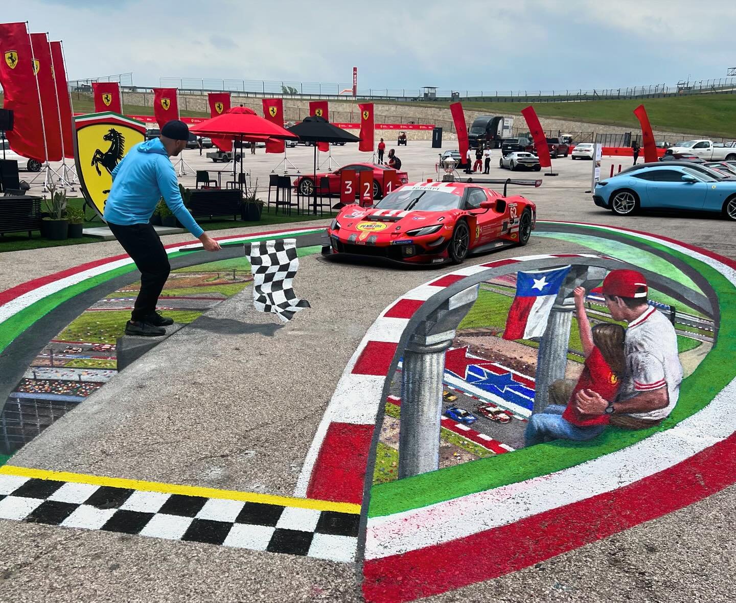 New Ferrari 3D street painting at @cota_official in Austin, TX with @chriscarlsonart! What an amazing world behind the scenes at the Ferrari Challenge that I know very little about. Might be one of my favorite settings for a painting as a car rolls i
