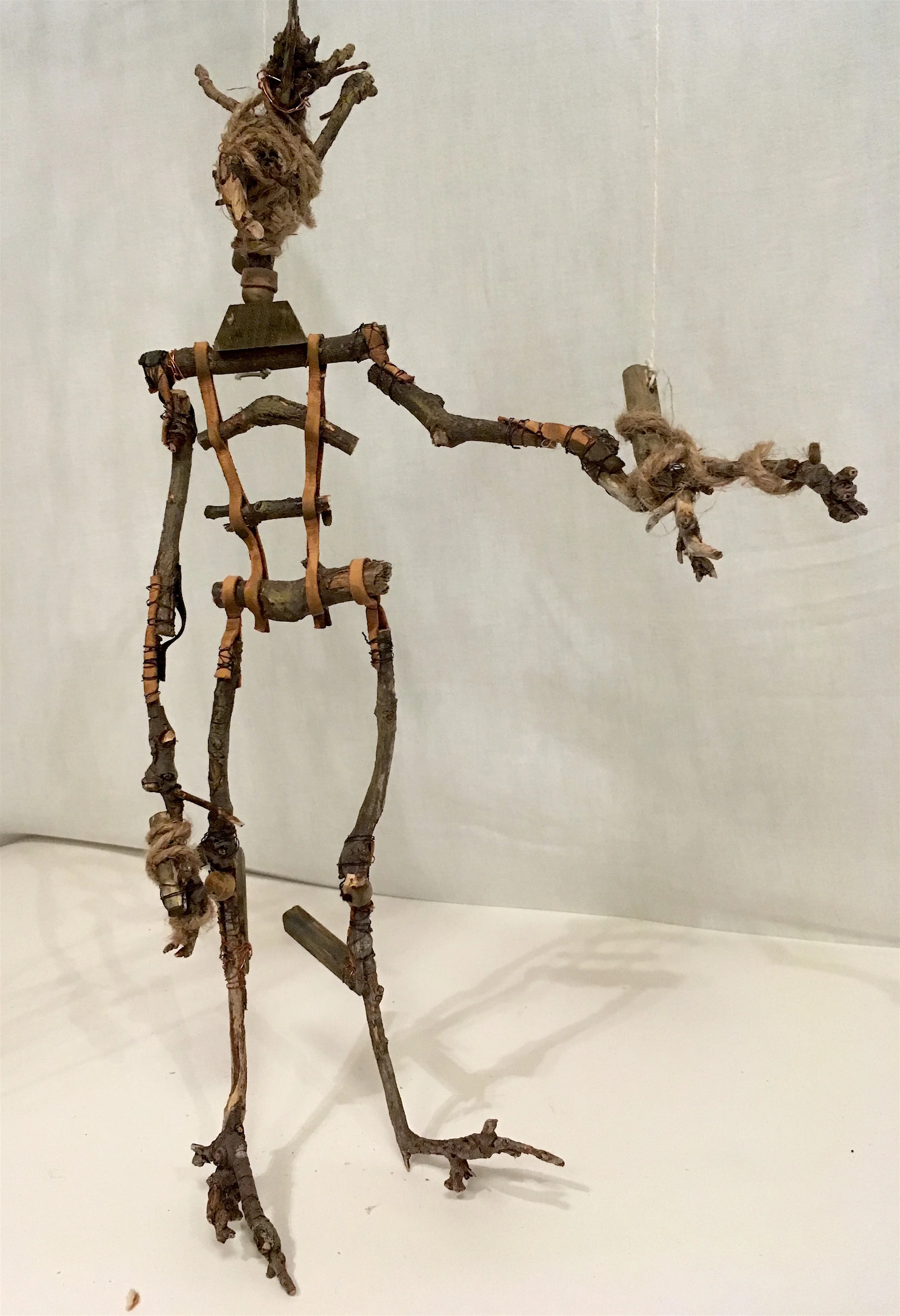 found sticks and roots, leather, wire, hemp twine, wooden beads, elastic, contact cement and paint