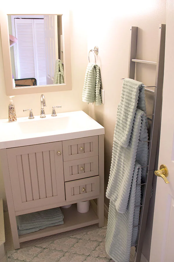 Martha Stewart vanity and Mirror. Magazine rack serves as towel rack.
