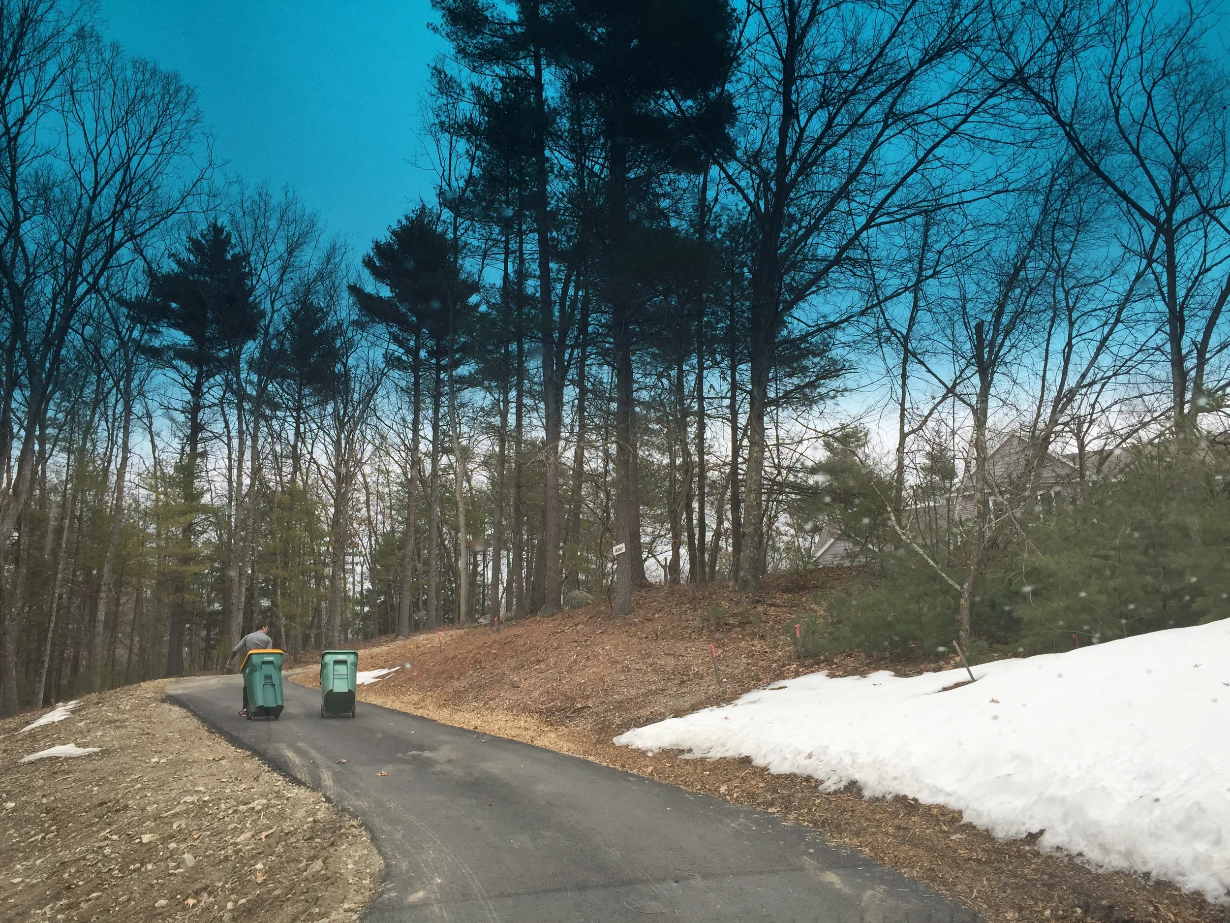 We have trash pick up! A huge deal as our garbage has been piling up. Nicholas is pulling the right bucket up the drive.