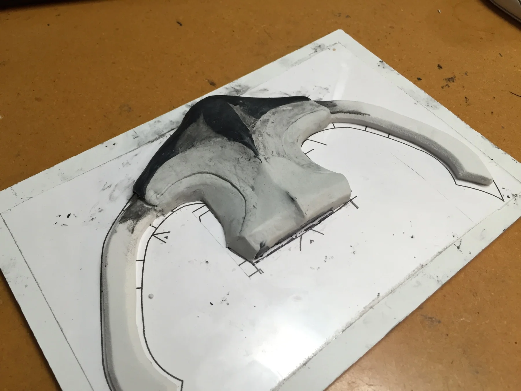Blocking out the rough base for the Hilt. White craftfoam added here to bulk up the crossbrs. The Black material is also Apoxie Sculpt.