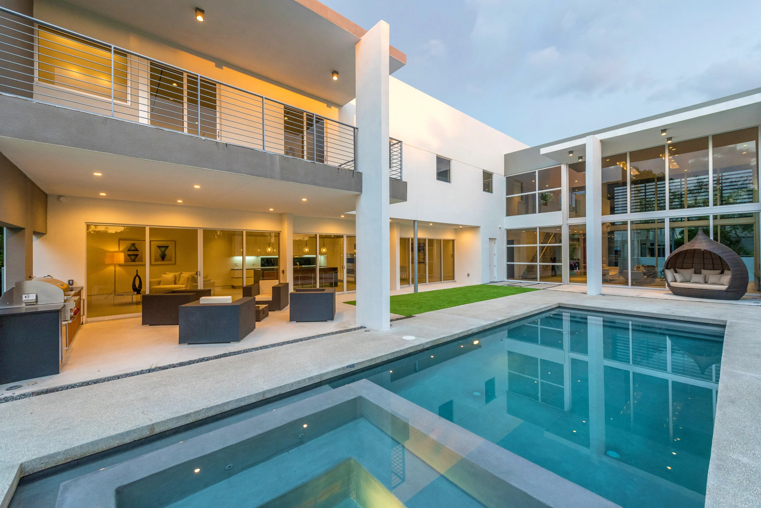 The Setting Homes Plum House Miami Florida Exterior Pool Dusk TARIS Real Estate