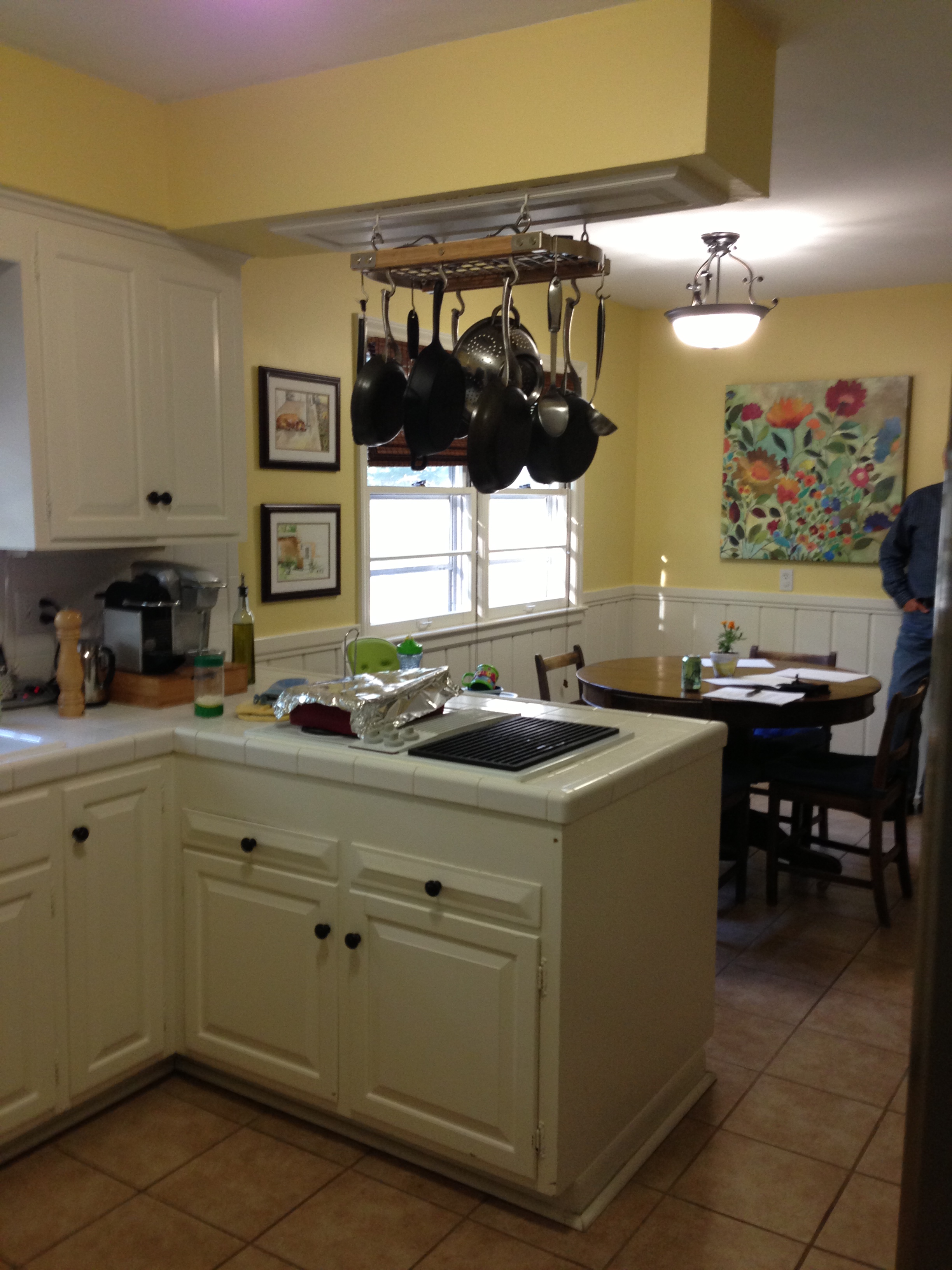 The old cooktop was inadequate and unsafe. The cabinet face frame and shelving prevented large cookware from being stored inside. Headroom and ventilation were insufficient. It was cut into the existing countertop, and was neither wired nor secured correctly. One element the homeowners loved was the natural light from the window. More on that in a minute.