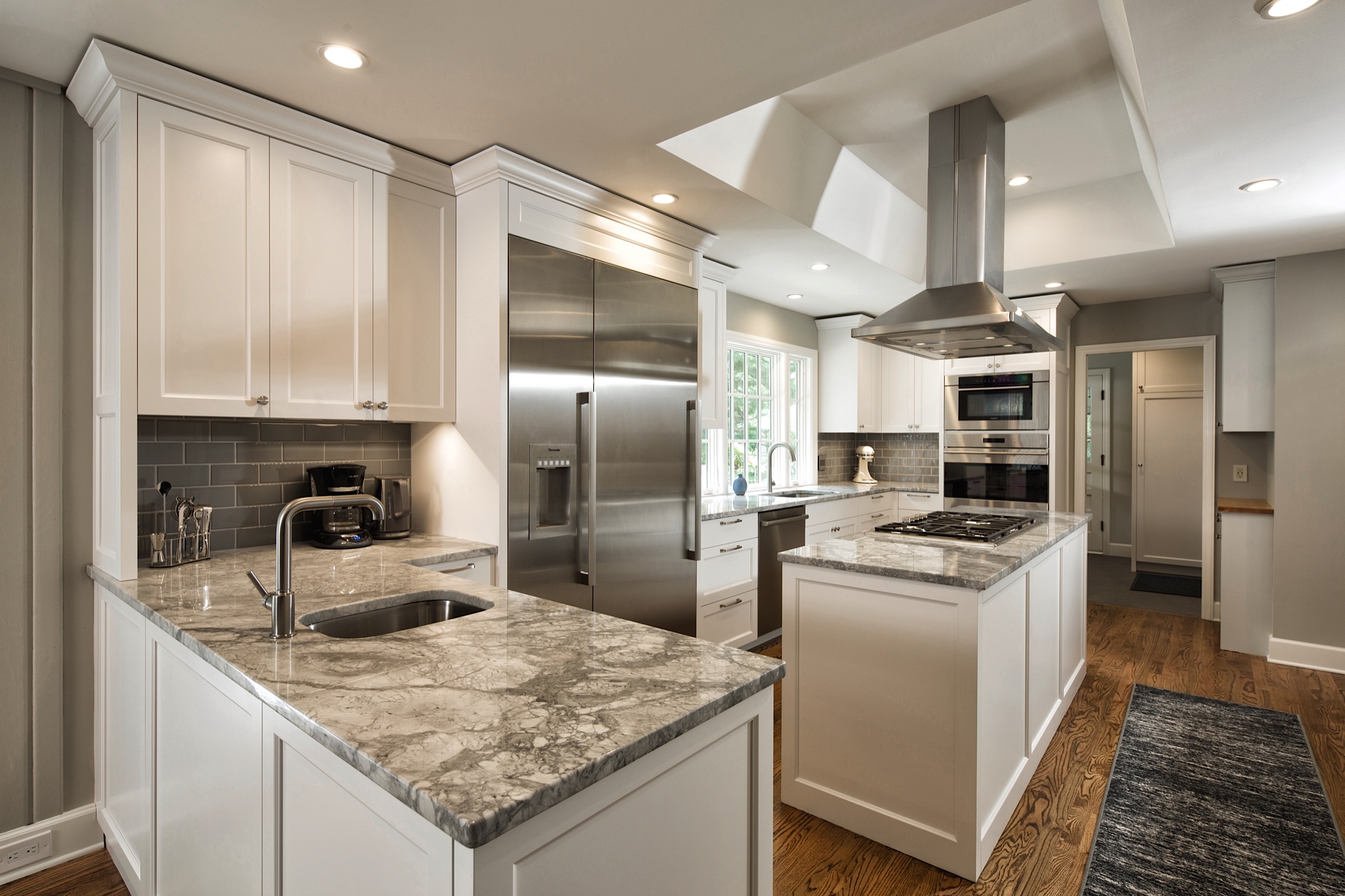 In the Client’s own words: “The kitchen is awesome with a great design, beautiful cabinetry, new appliances, lots of storage, impressive countertops, a large window, and many small details that make it nice to be and work in. Opening up the staircase wall, adding a tray ceiling, and removing the wall to the family room makes it seem very spacious.”