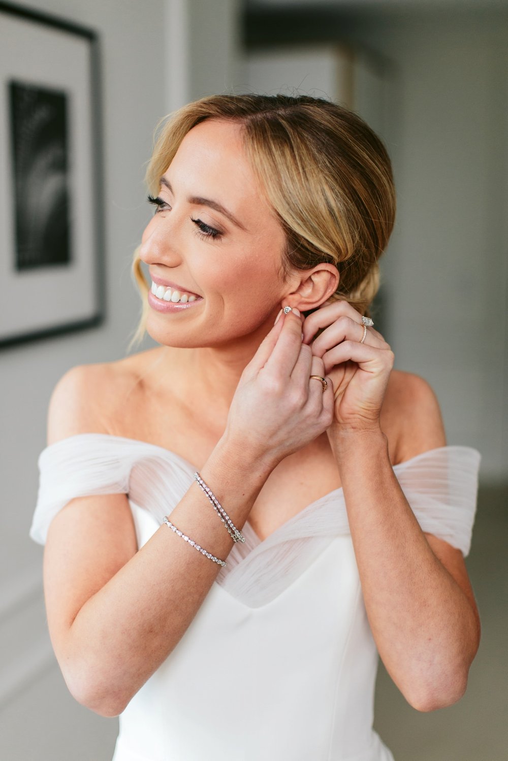 chicago bride putting on earrings