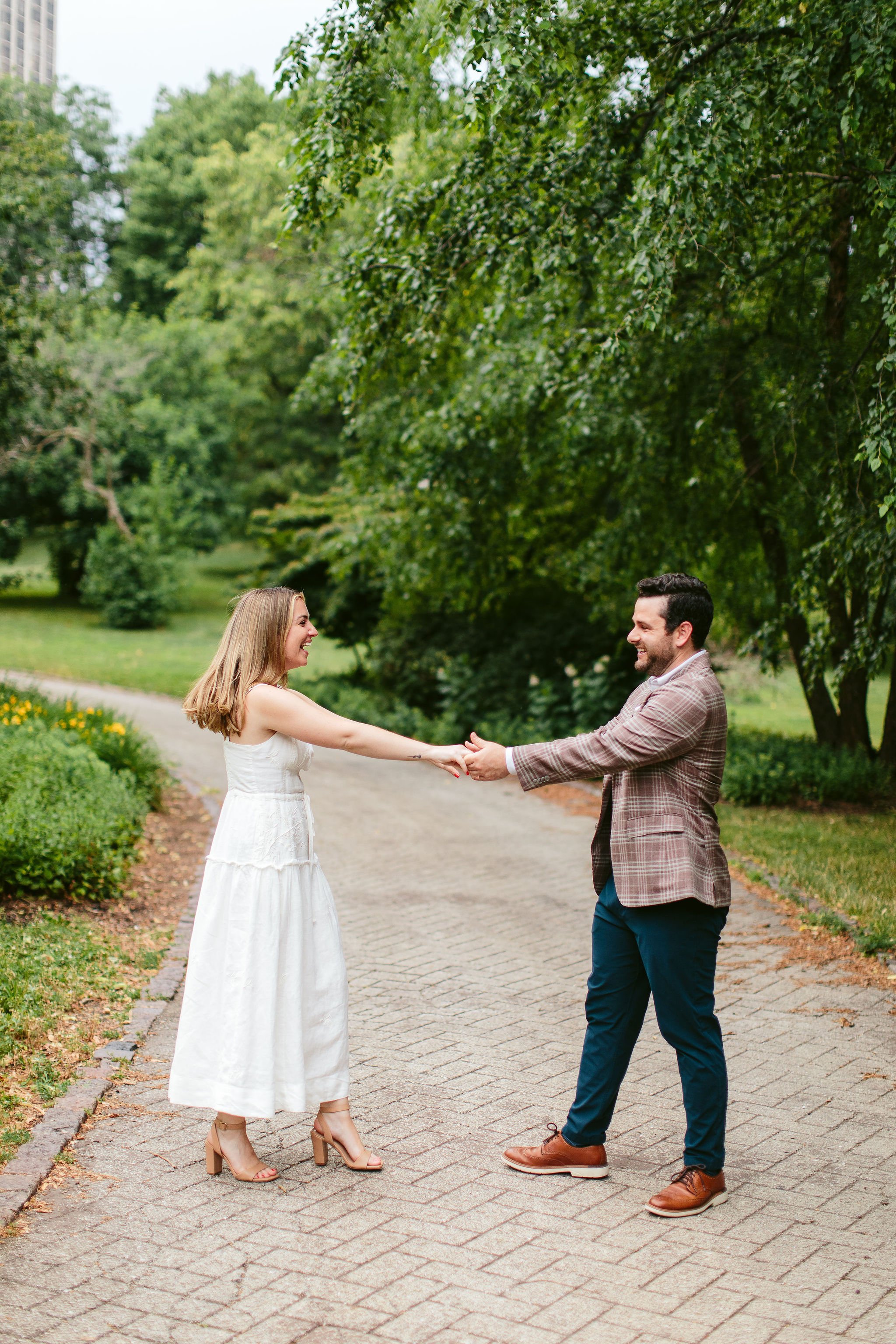 young couple dancing during engagement photos at North Pond Chicago