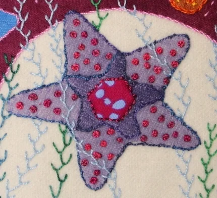 The Coral Stitch is done around the edge of the Starfish in a blue Valdani© size 8 cotton.