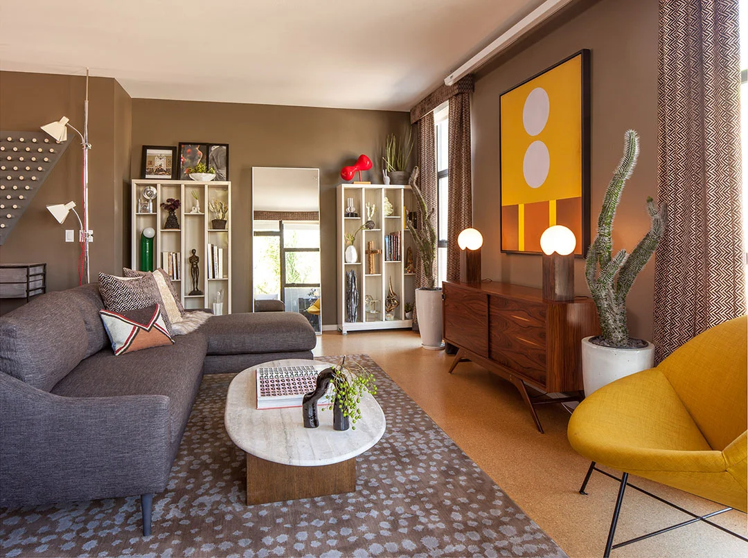Custom built couch, designed by We Came In Peace. Pillows by Christian Rathbone and Cloudhunter. Rug by Calvin Klein Home.