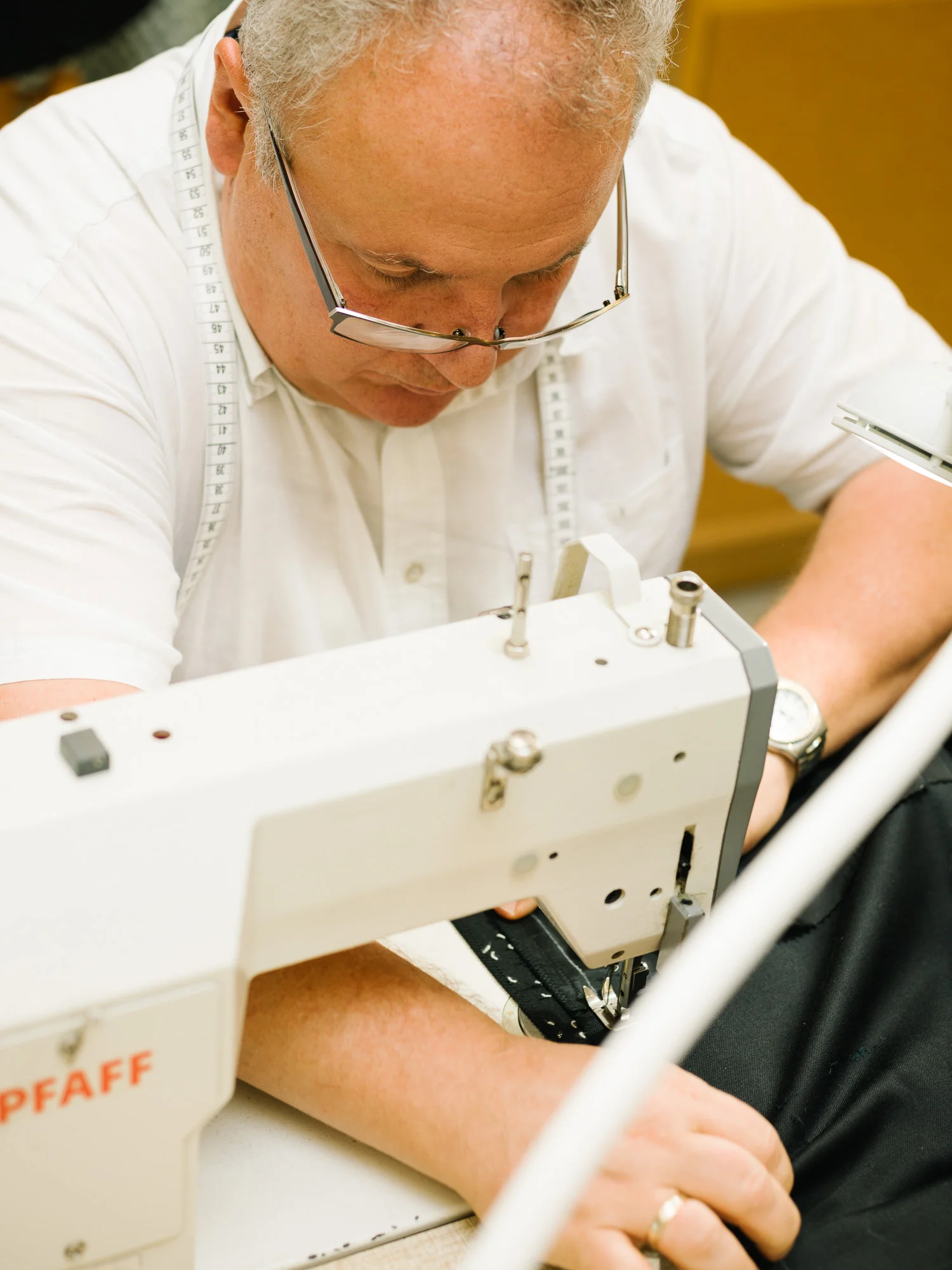 VIENNA, AUSTRIA - September 17,2018: At the men's props tailor shop of the Vienna State Opera. Johann Jokl using a sewing machine.