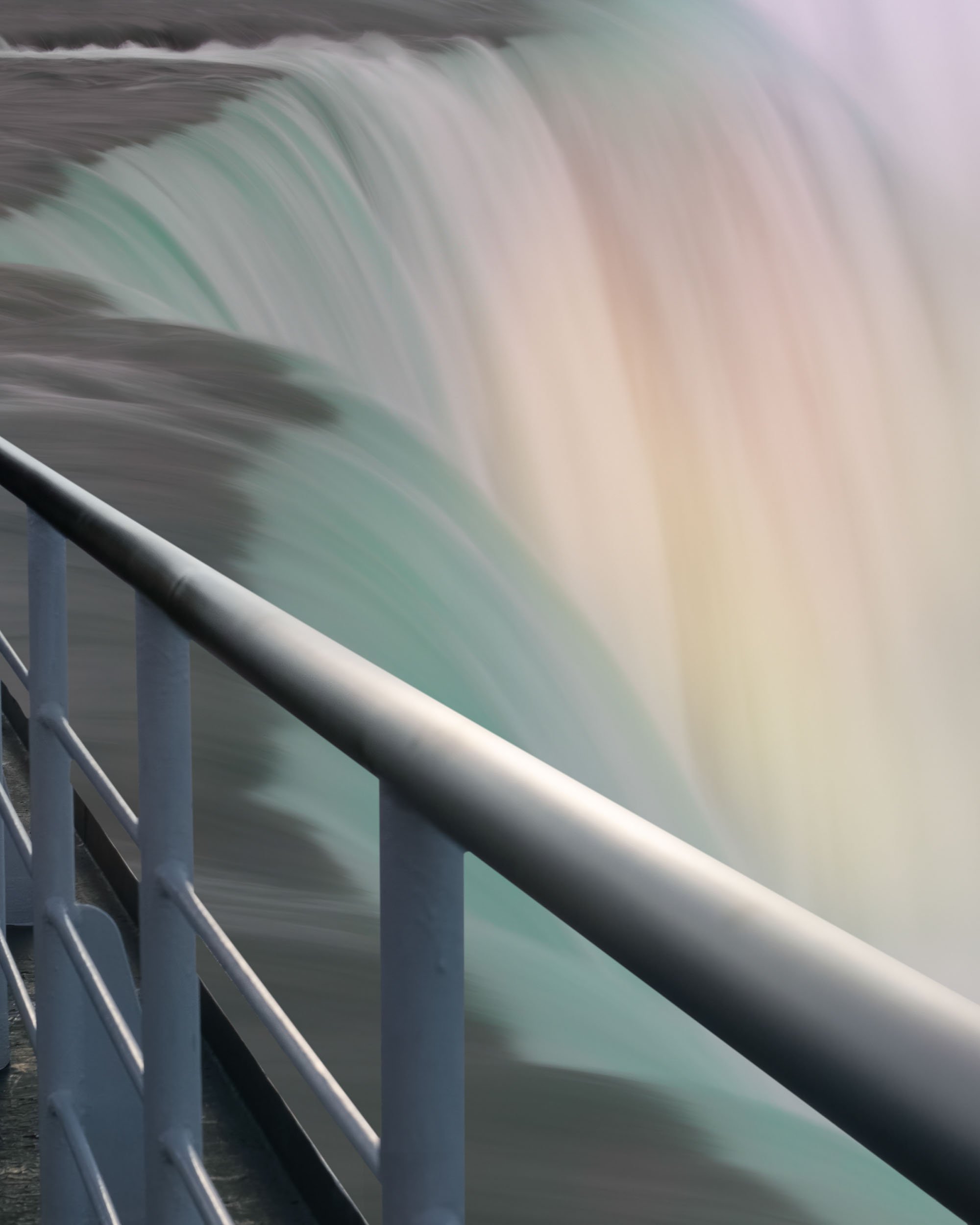 作品《靜觀》的局部特寫，展示前景的金屬欄杆與背景瀑布的並置，詮釋現實與夢境的交界。