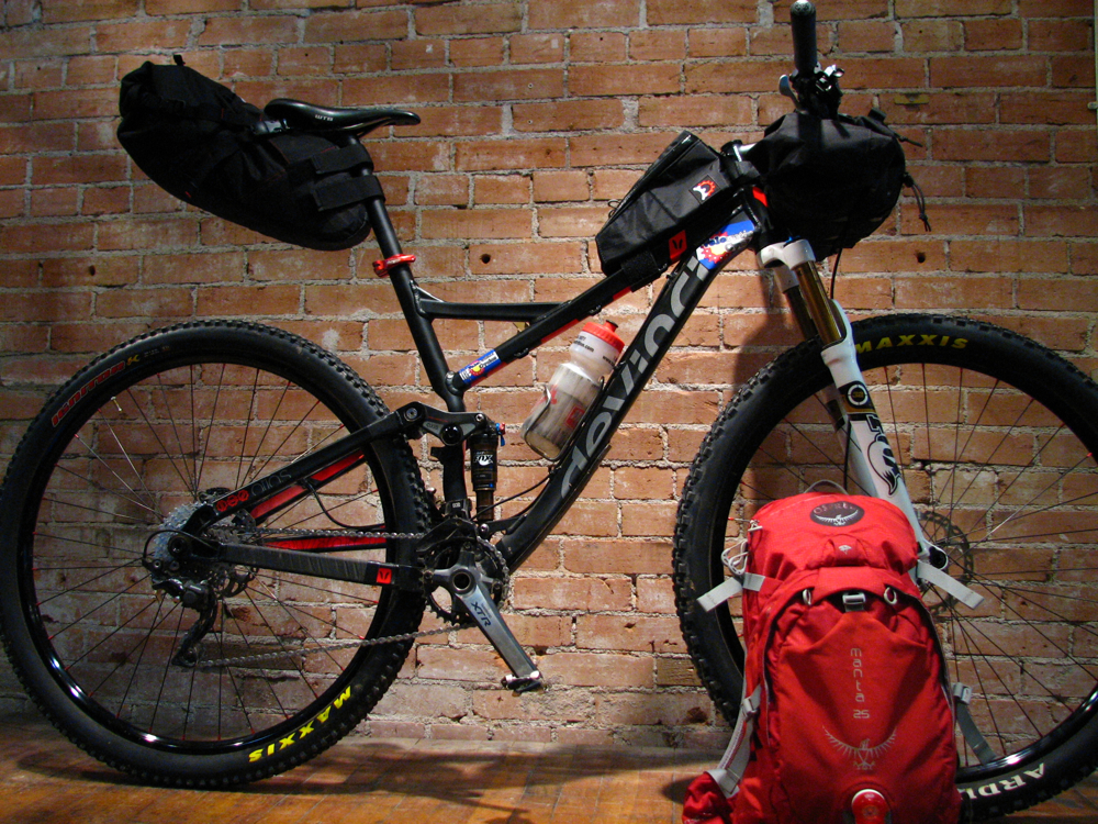 Joey's previous bike, a Devinci Atlas, ready to go for the 2013 CTR. Bedrock Bags' Entrada handlebar bag/pocket and Revelate Designs' Gas Tank and Viscacha seatbag, used in conjunction with Osprey's Manta 25 pack, provided plenty of room.