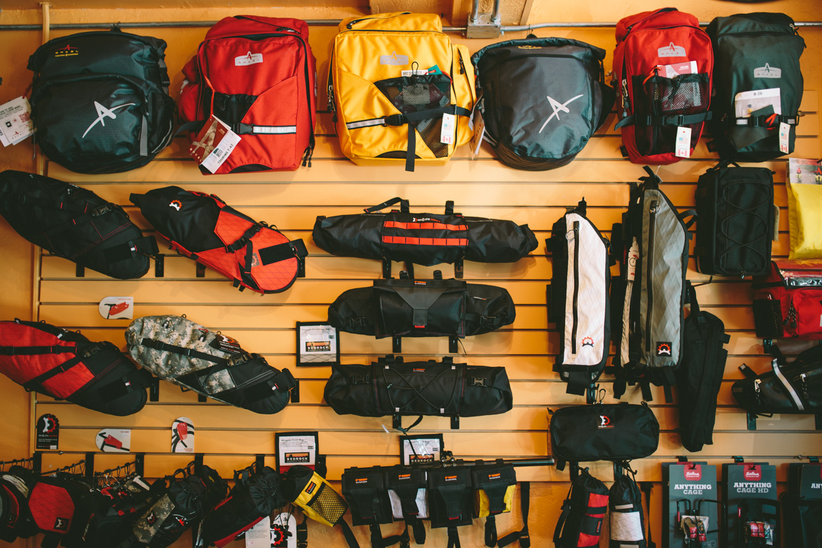 Our bikepacking / touring wall as of several weeks back. Generally lots more in backstock - just not right now. Photo cred: Logan from Pedaling Nowhere!