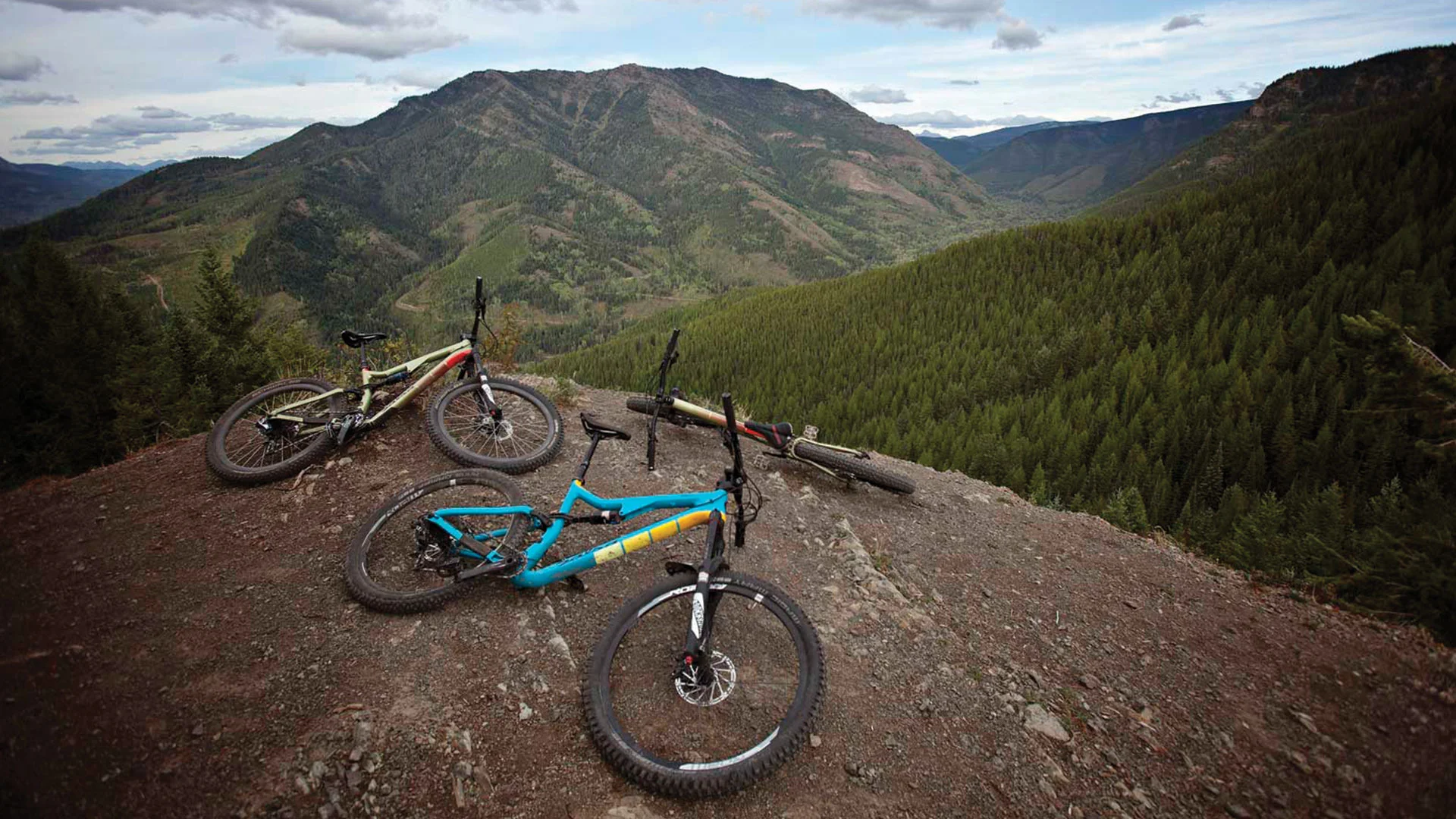 Three bikes hangin' out on a mountaintop.