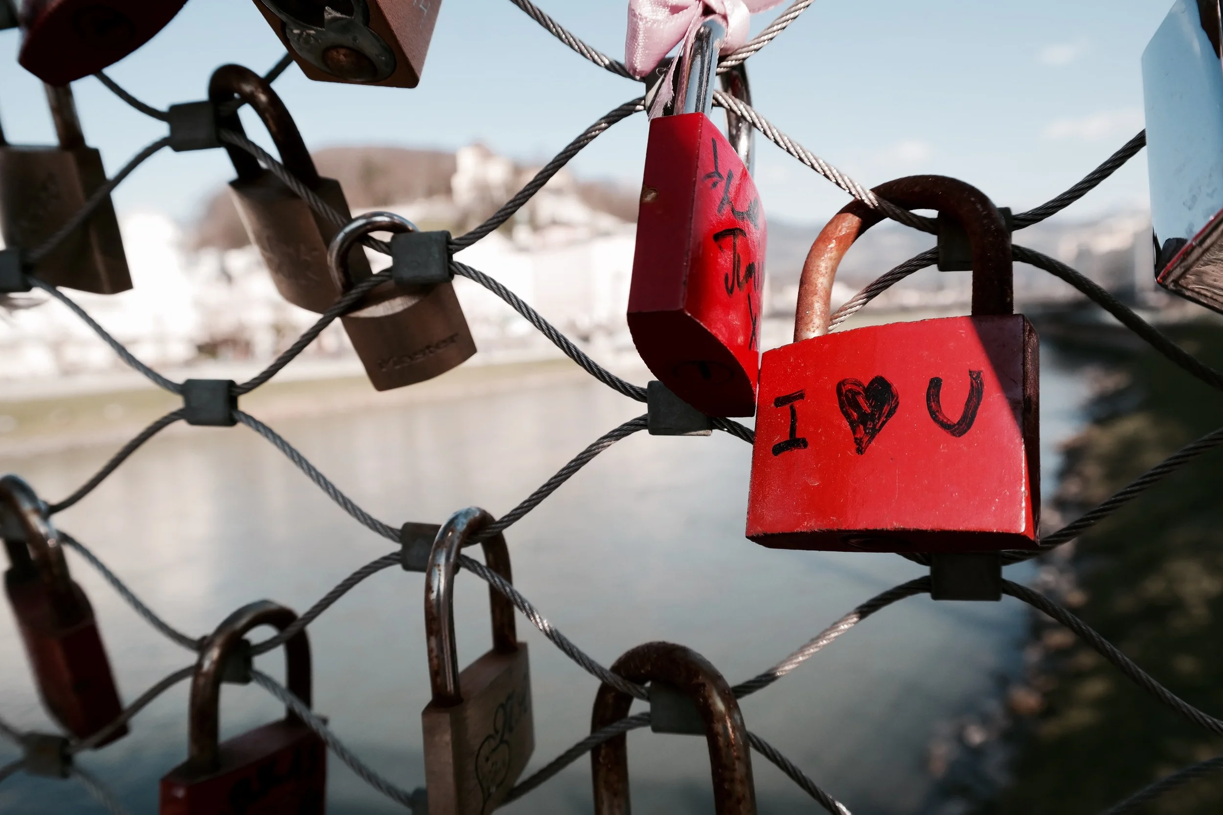 A bridge over the river with tons of locks.