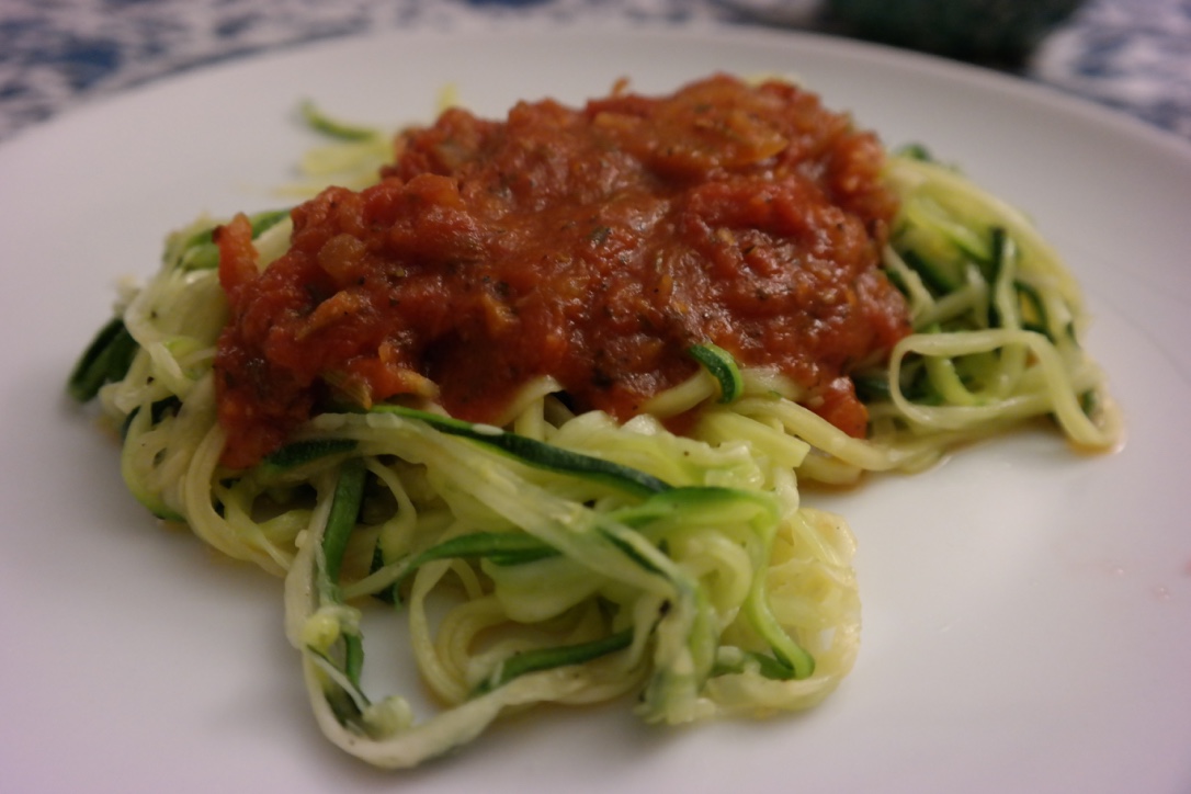 Zucchini noodles with pasta sauce . This recipe was John's idea, and after he ordered a special "noodle" cutter on Amazon, he made a homemade pasta sauce to go along with the zucchini "noodles." I loved it!