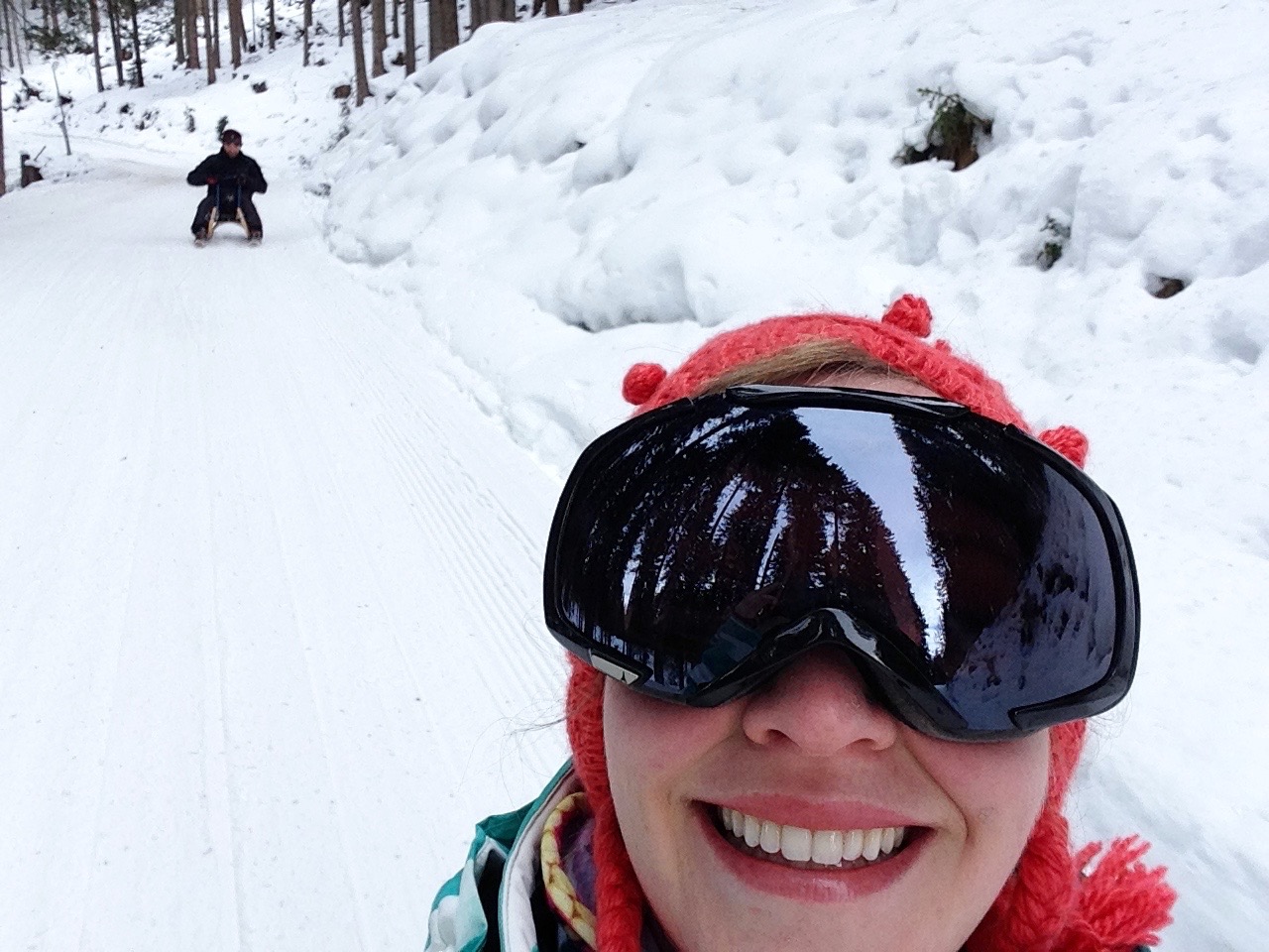Action shot on the 8km sledding course. This was kind of dangerous, considering that I cannot multitask, but I managed not to go off the side of the mountain (which was strangely unprotected by barriers...), so all is well.