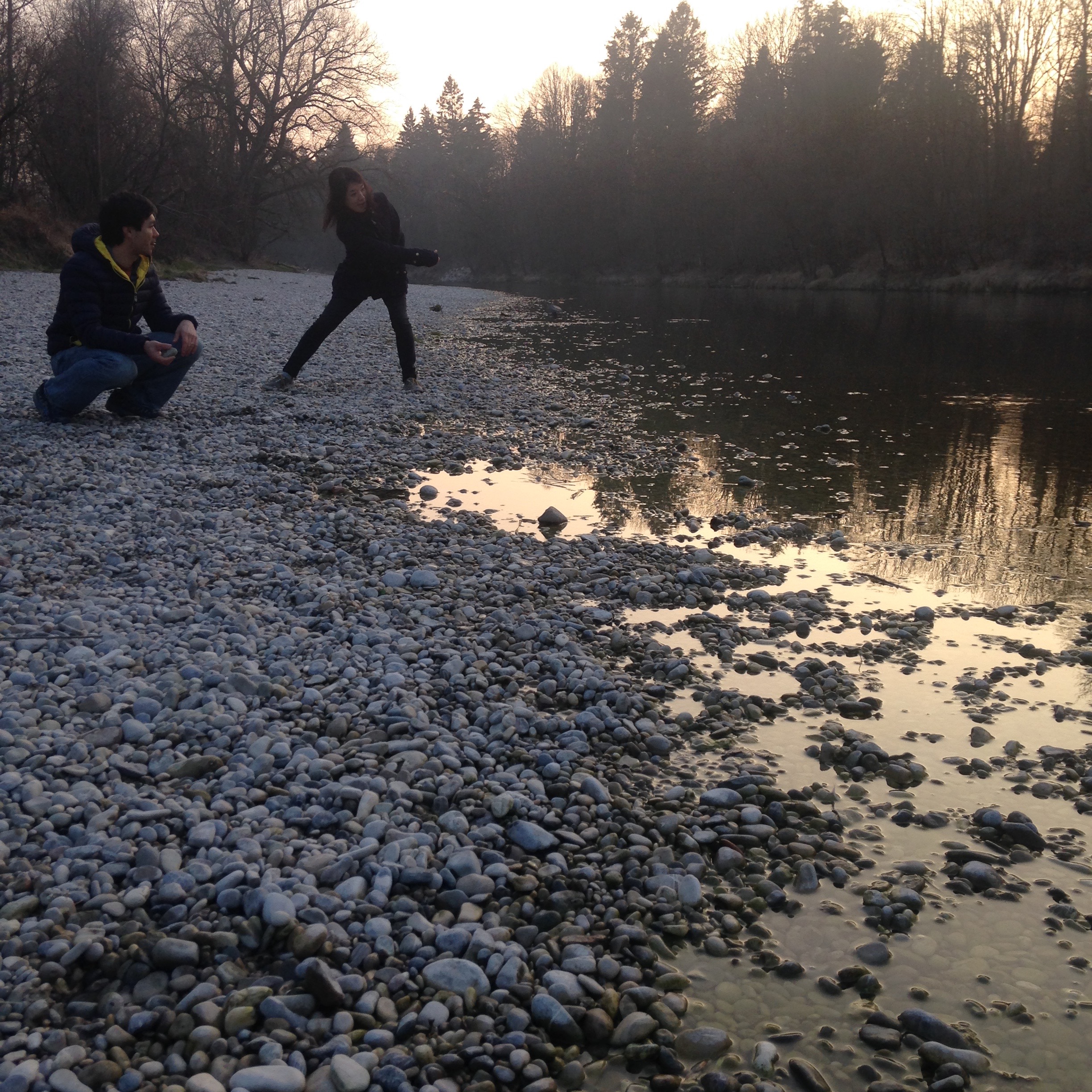 Skipping rocks on the river with friends.