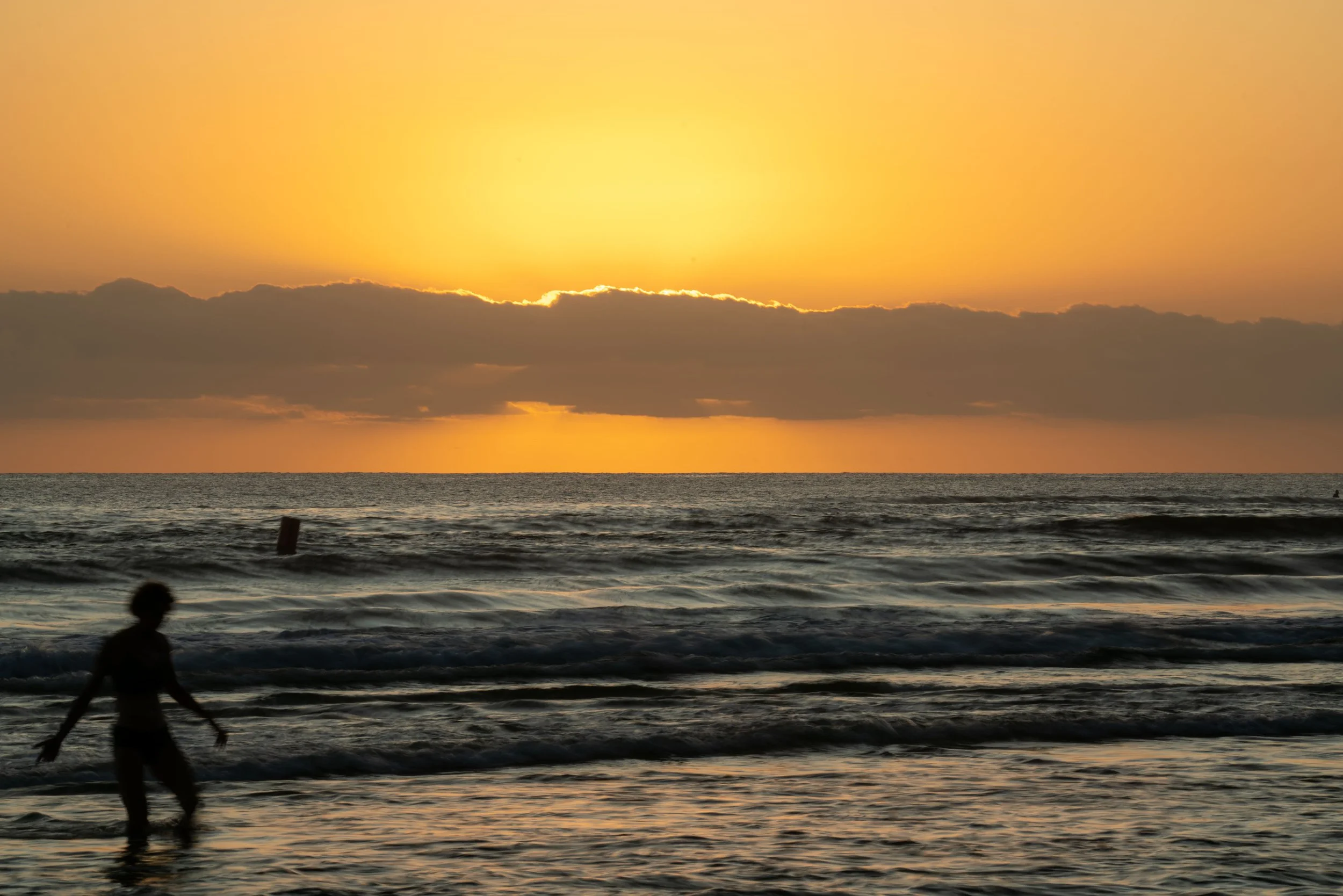 Burleigh Mar 22-rising sun behind -lone bather (1 of 1).jpg