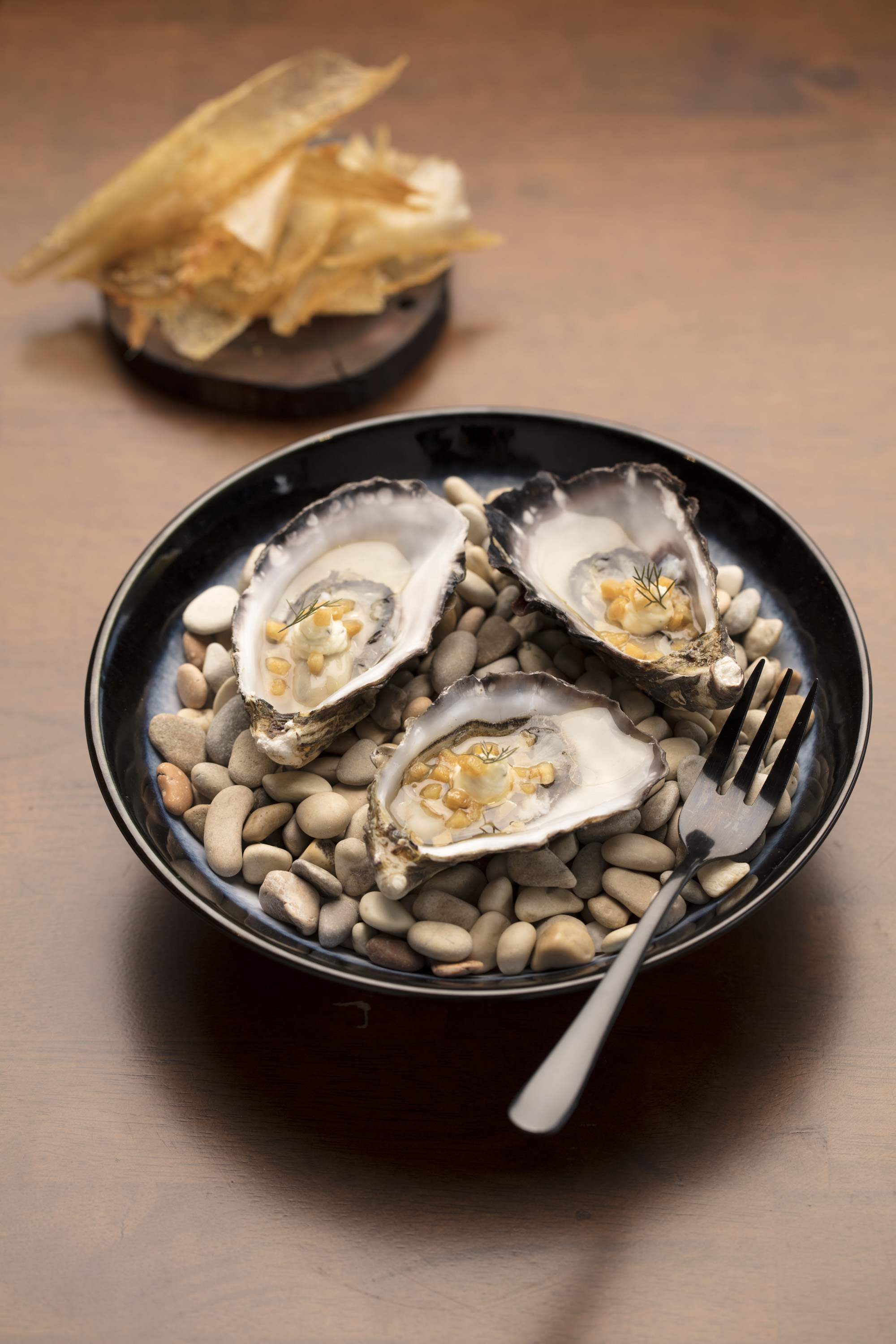  The North Room, Mermaid Beach. "Oyster, smoked pork fat, rosemary, lemon and smaller dish is Crispy chicken skin with gherkin salt" 