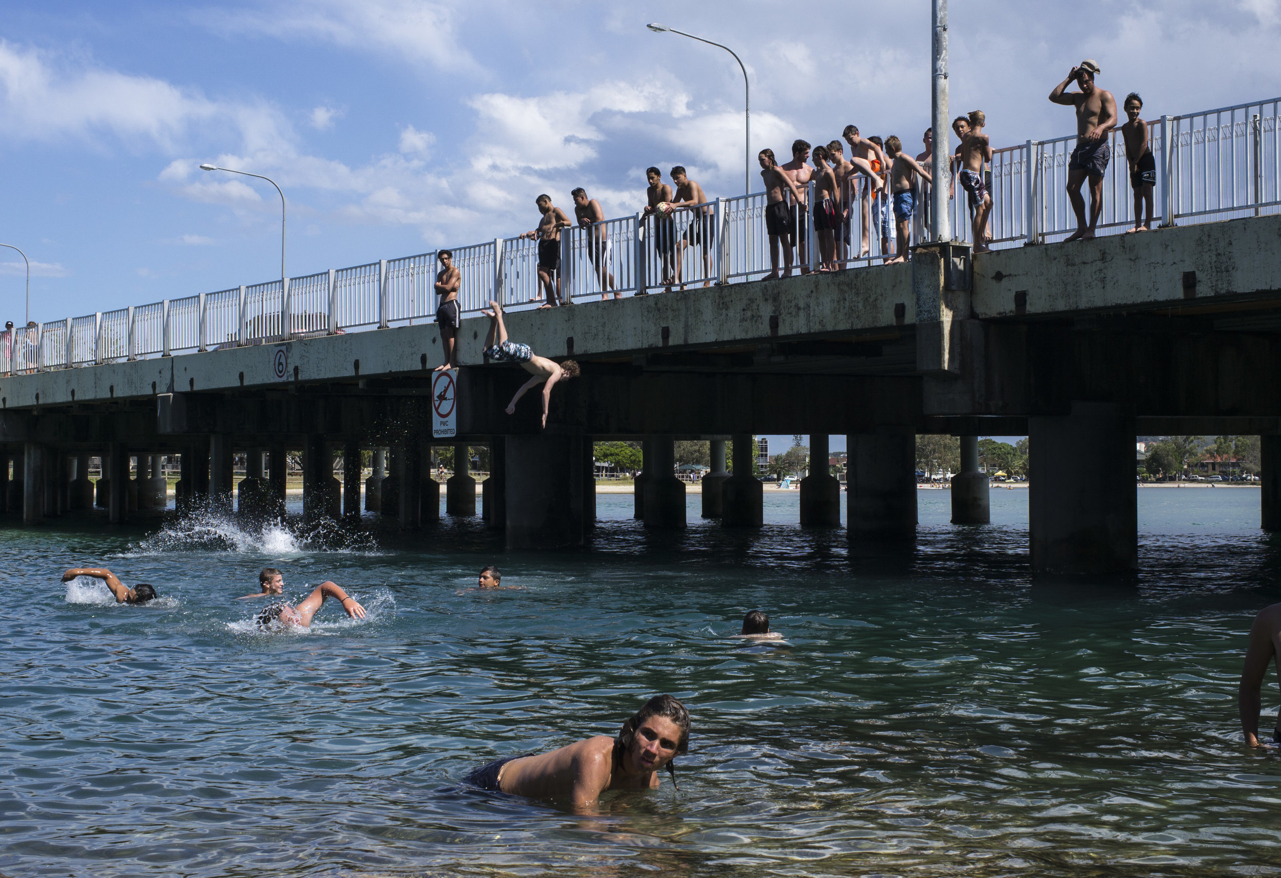  Jumpers line the bridge that crosses over Tallebudgera Ck, Gold Coast, Qld, Australia 