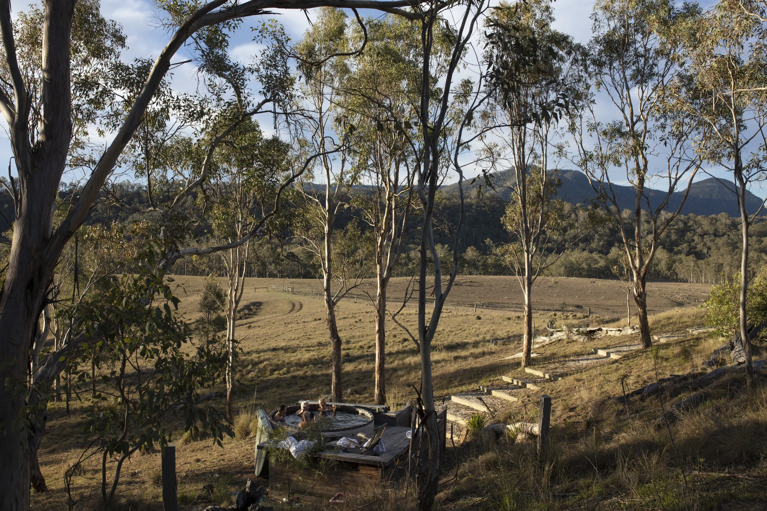  Qantas Magazine/Scenic Rim Walk.
Walkers arriving at Spicers Canopy. Hot tub and drinks after a full days walking. 
Mount Mitchell in the background where the walkers have come from.Photography : Russell Shakespeare 