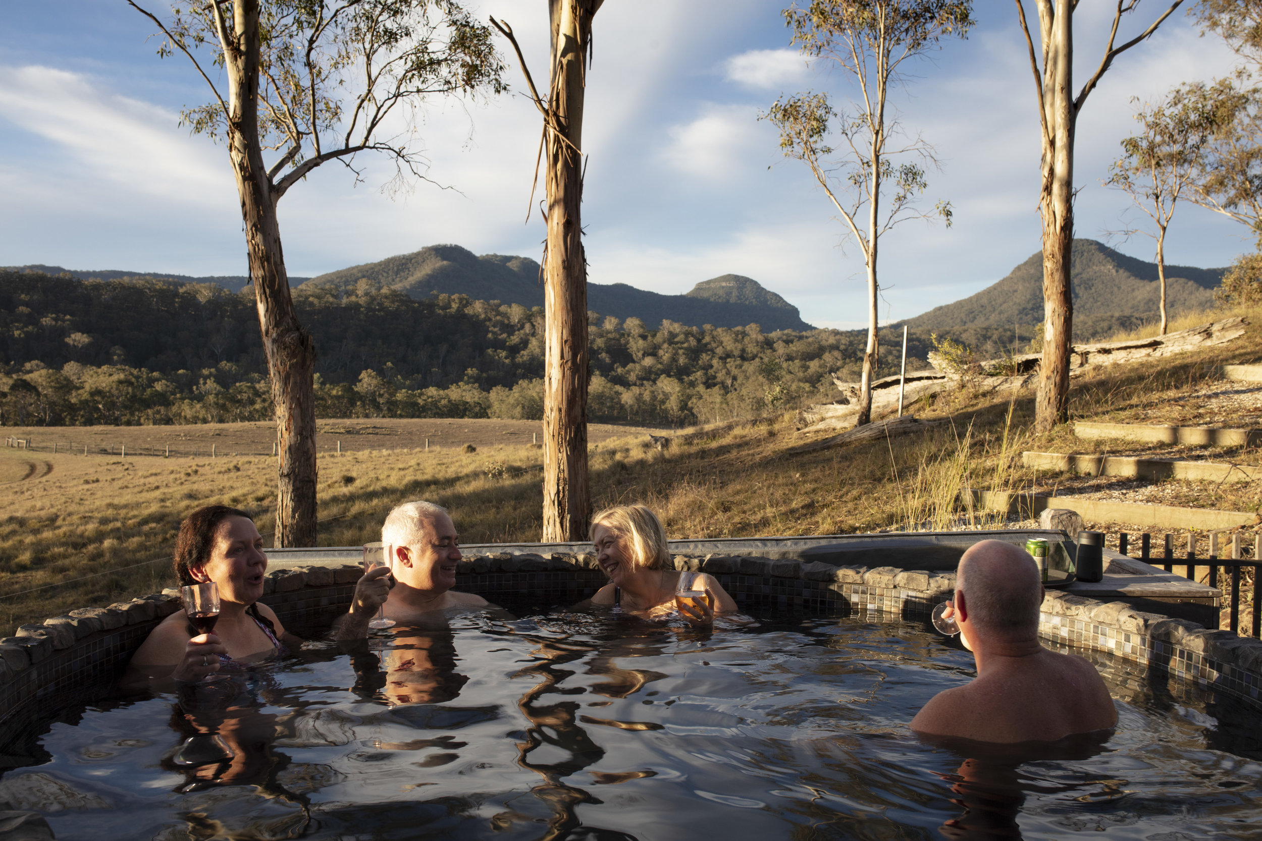  Qantas Magazine/Scenic Rim Walk.
Walkers arriving at Spicers Canopy. Hot tub and drinks after a full days walking. 
Mount Mitchell in the background where the walkers have come from.Photography : Russell Shakespeare 