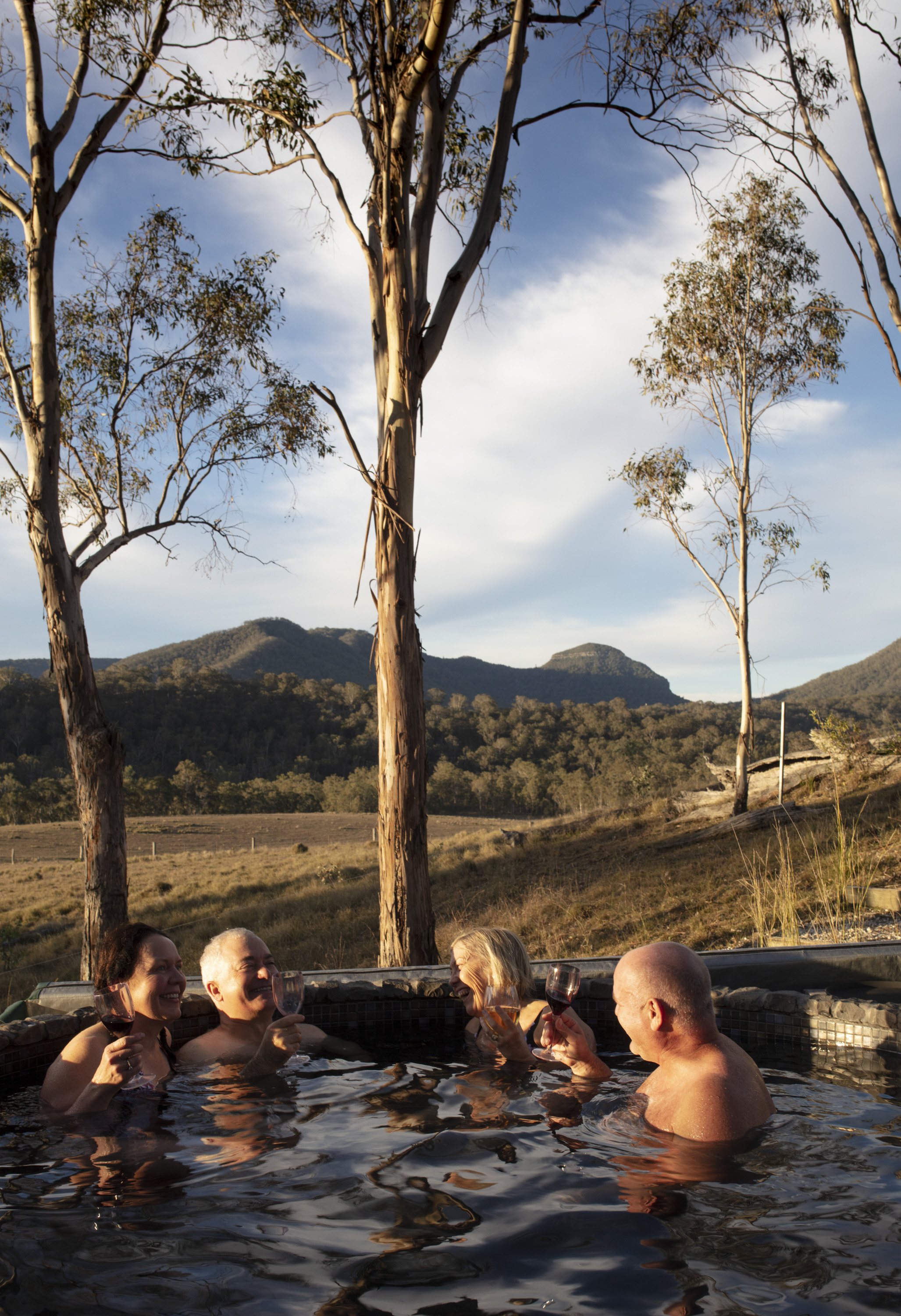  Qantas Magazine/Scenic Rim Walk.
Walkers arriving at Spicers Canopy. Hot tub and drinks after a full days walking. 
Mount Mitchell in the background where the walkers have come from.Photography : Russell Shakespeare 