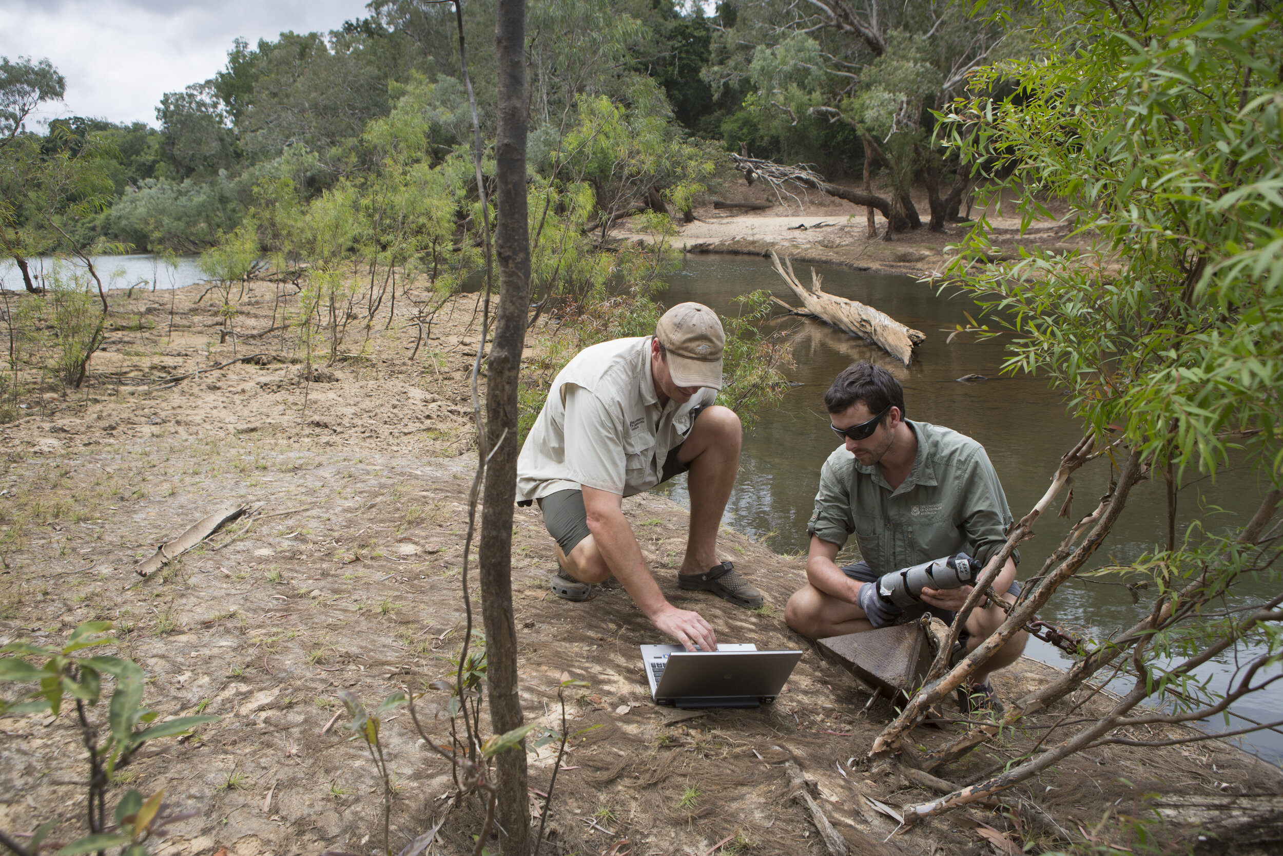  Dr Ross Dywer Post Doctoral Research Associate Uni of Qld, Pulling up passive acoustic receiver to download the presence of tagged crocodiles from the past 12 months.Dr Hamish Campbell Research Associate Uni of Qld checking results on laptop 
