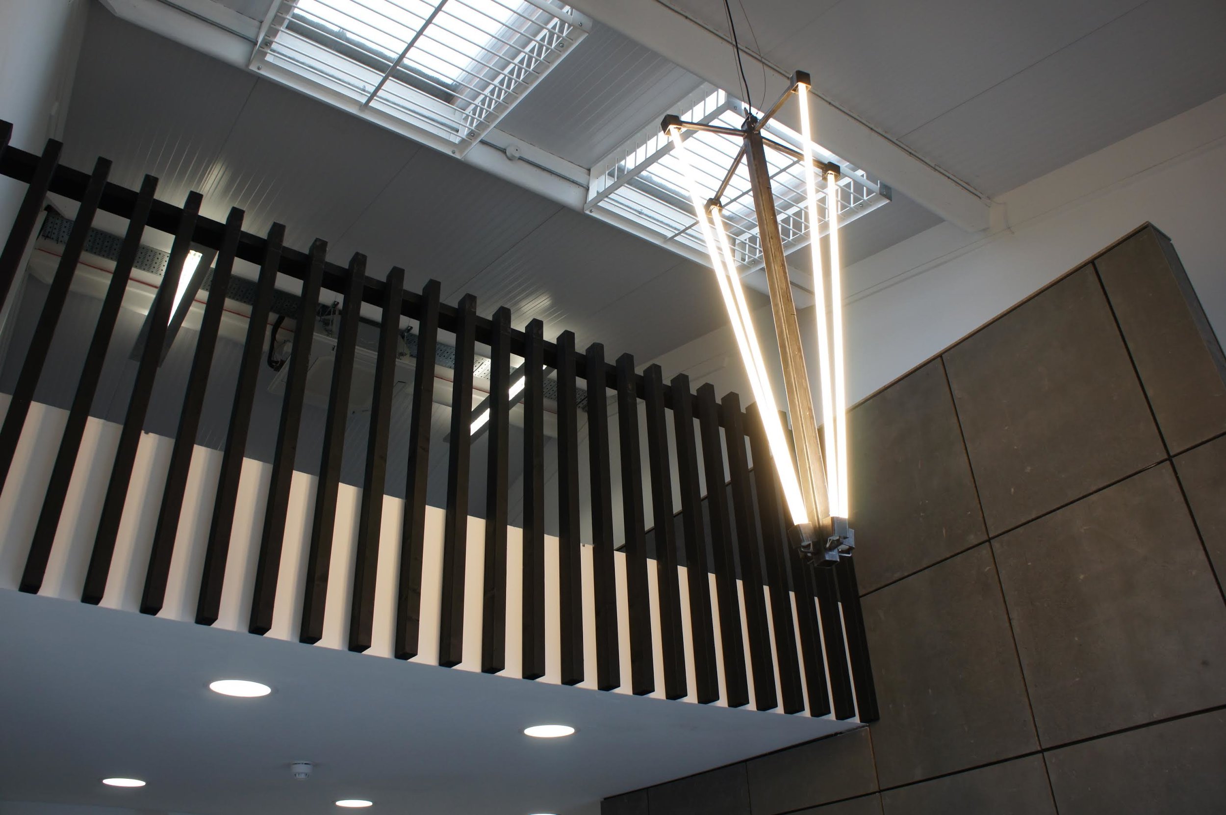High output vertical design for double height space and mezzanine