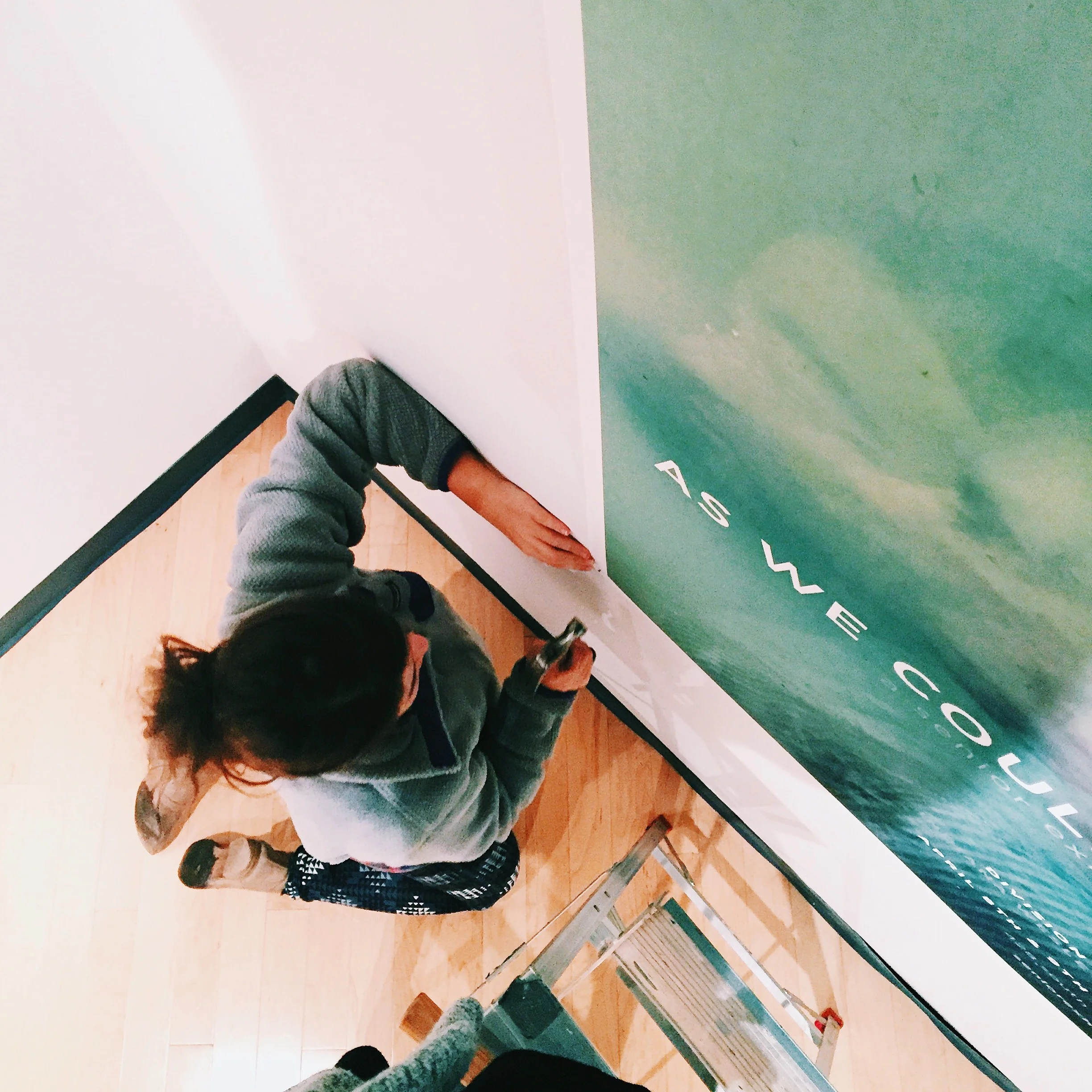 Hanging posters in the art gallery on campus.