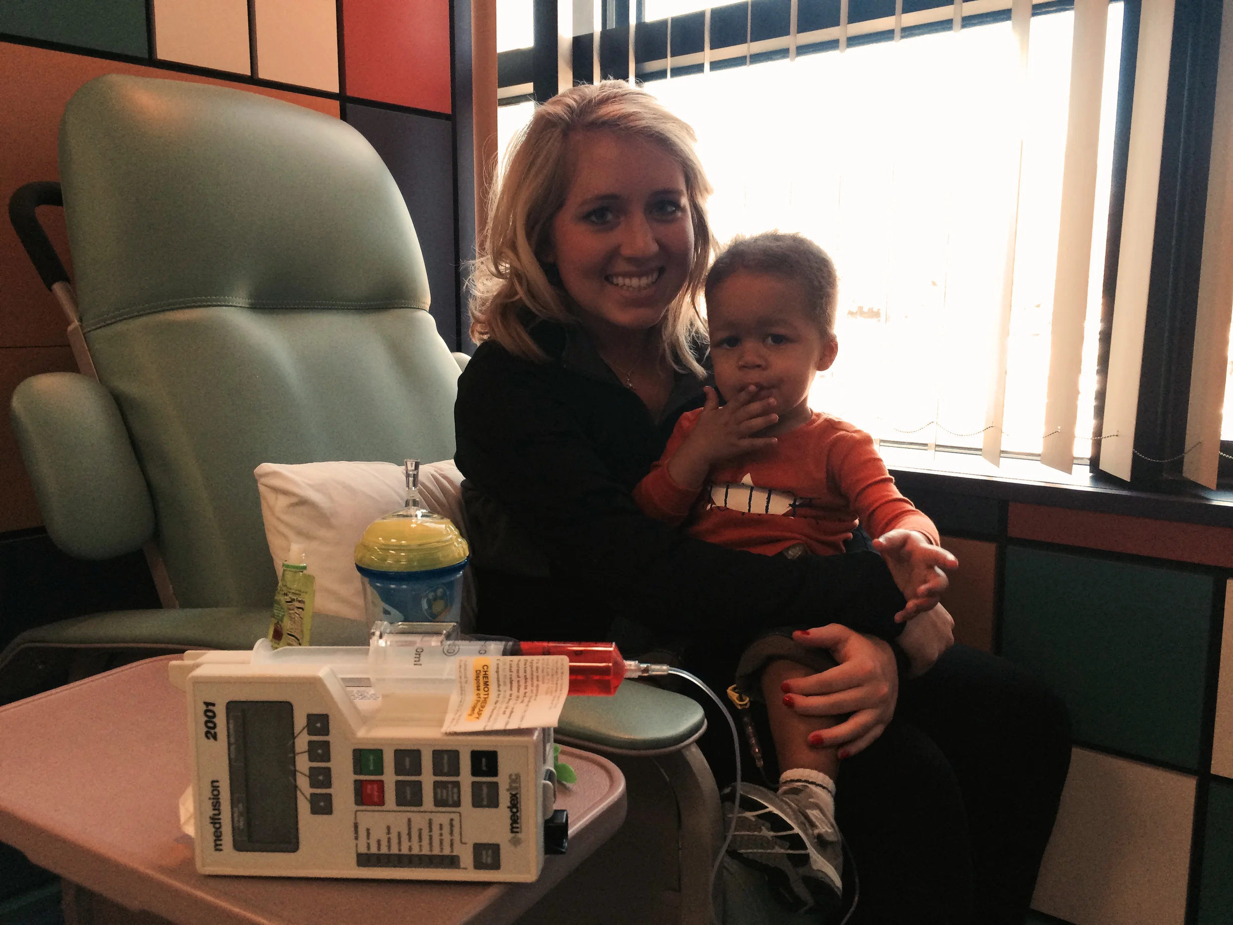 Day 179: Elliott sits with his nanny while receiving his chemotherapy infusion