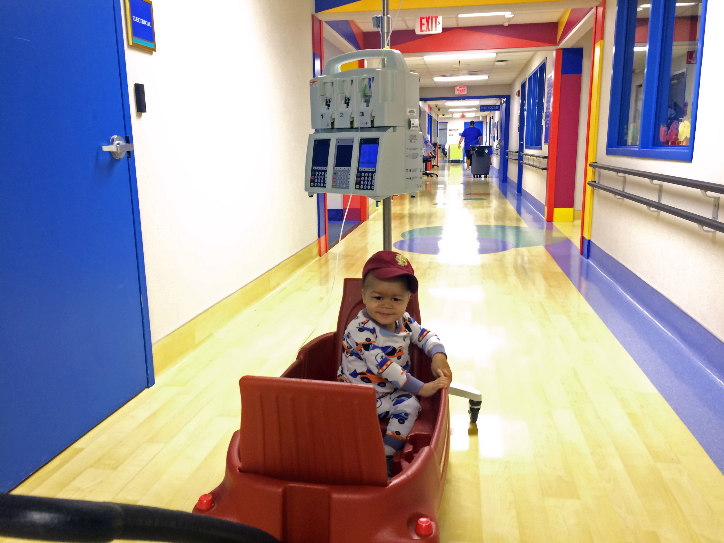 Day 205: Elliott takes a wagon ride around the oncology floor. This has become one of his favorite activities. A nurse showed Rachel how to tie the IV pole to back of the wagon to free up one hand.