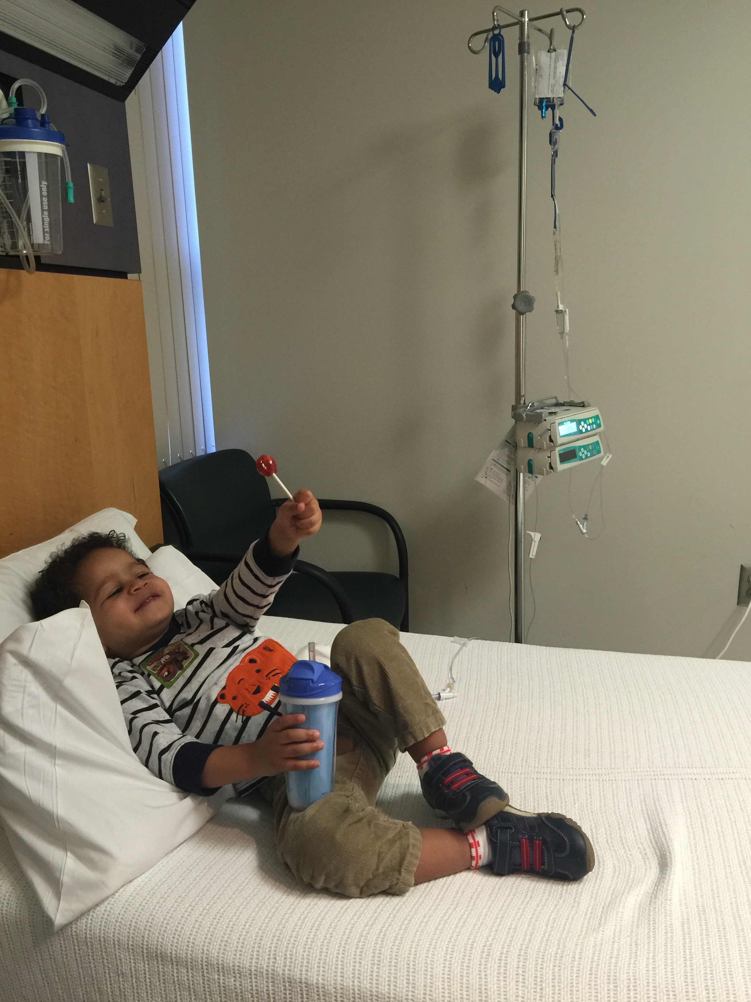 Day 570: Elliott enjoys a lollipop while at chemo. He has learned that we generally let him whatever he wants while at clinic.