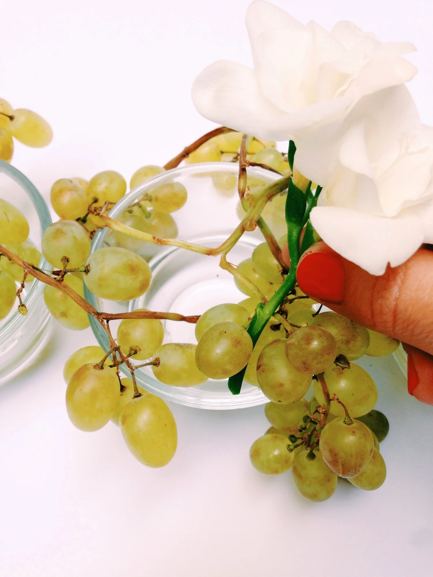 place the main white flowers into the grapes, making sure they stay in place where you want them