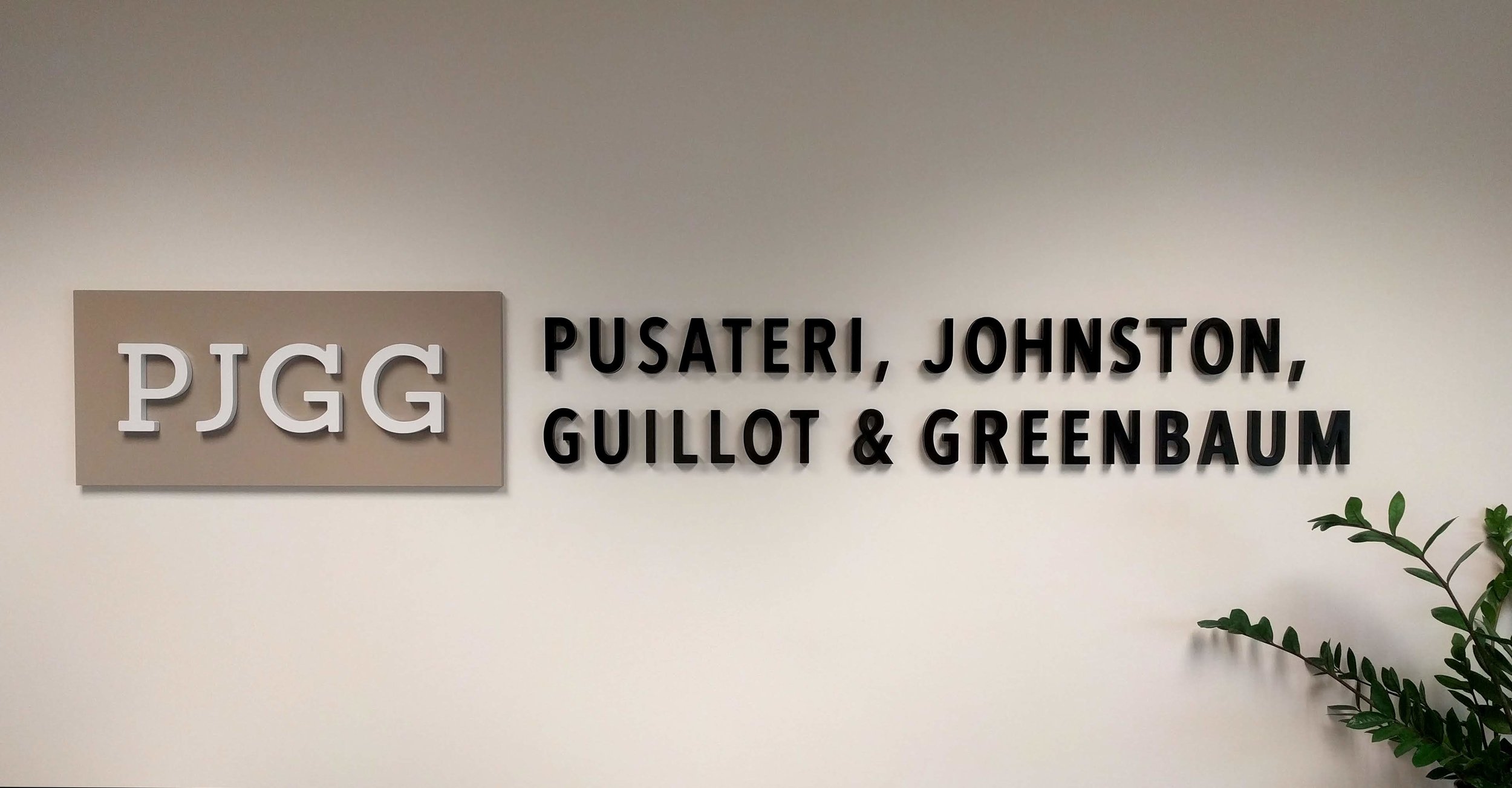 Wall-mounted, floating painted acrylic lettering- PJGG: Pusateri, Johnston, Guillot &amp; Greenbaum.