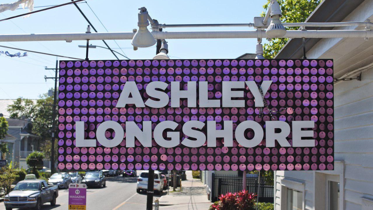 Hanging aluminum cabinet covered in large, pink confetti with floating acrylic lettering: Ashley Longshore