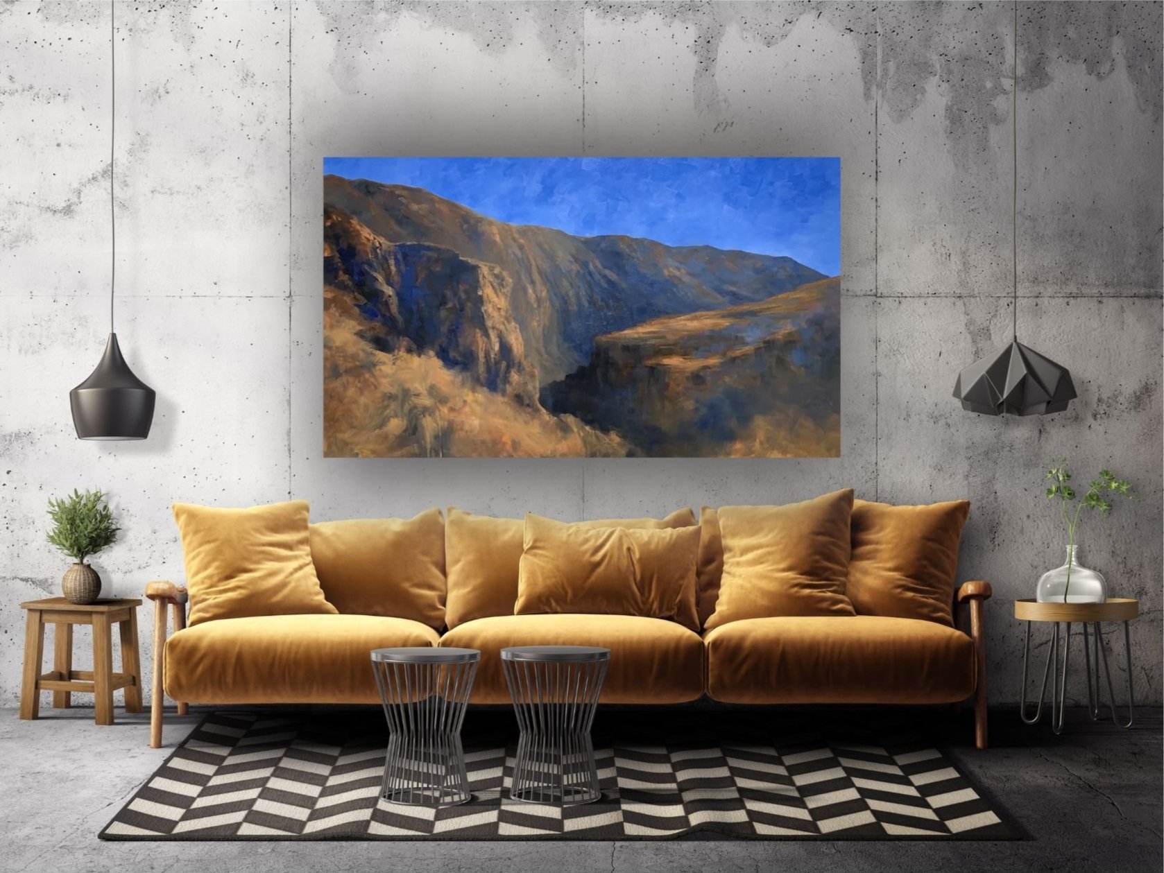 Modern living room in stylish home with large landscape painting above sofa, of desert mountains