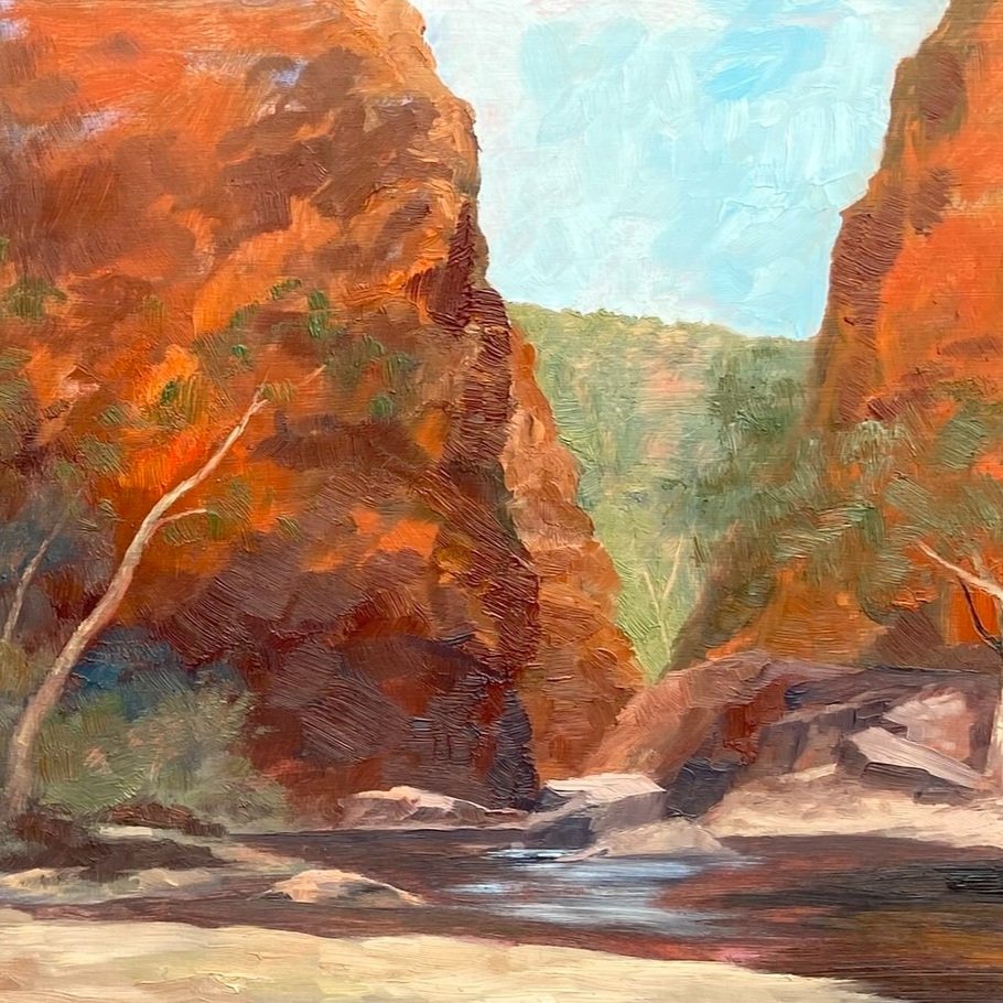 Painting of red-orange gorge in desert mountains with creek and ghost gums in foreground