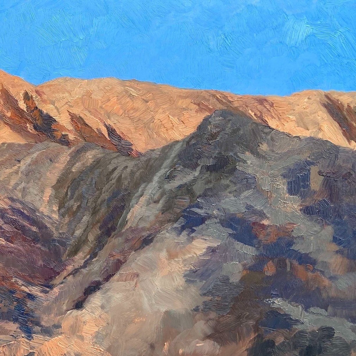 Oil painting made en plein air of desert mountains, with dark shadow and deep blue sky