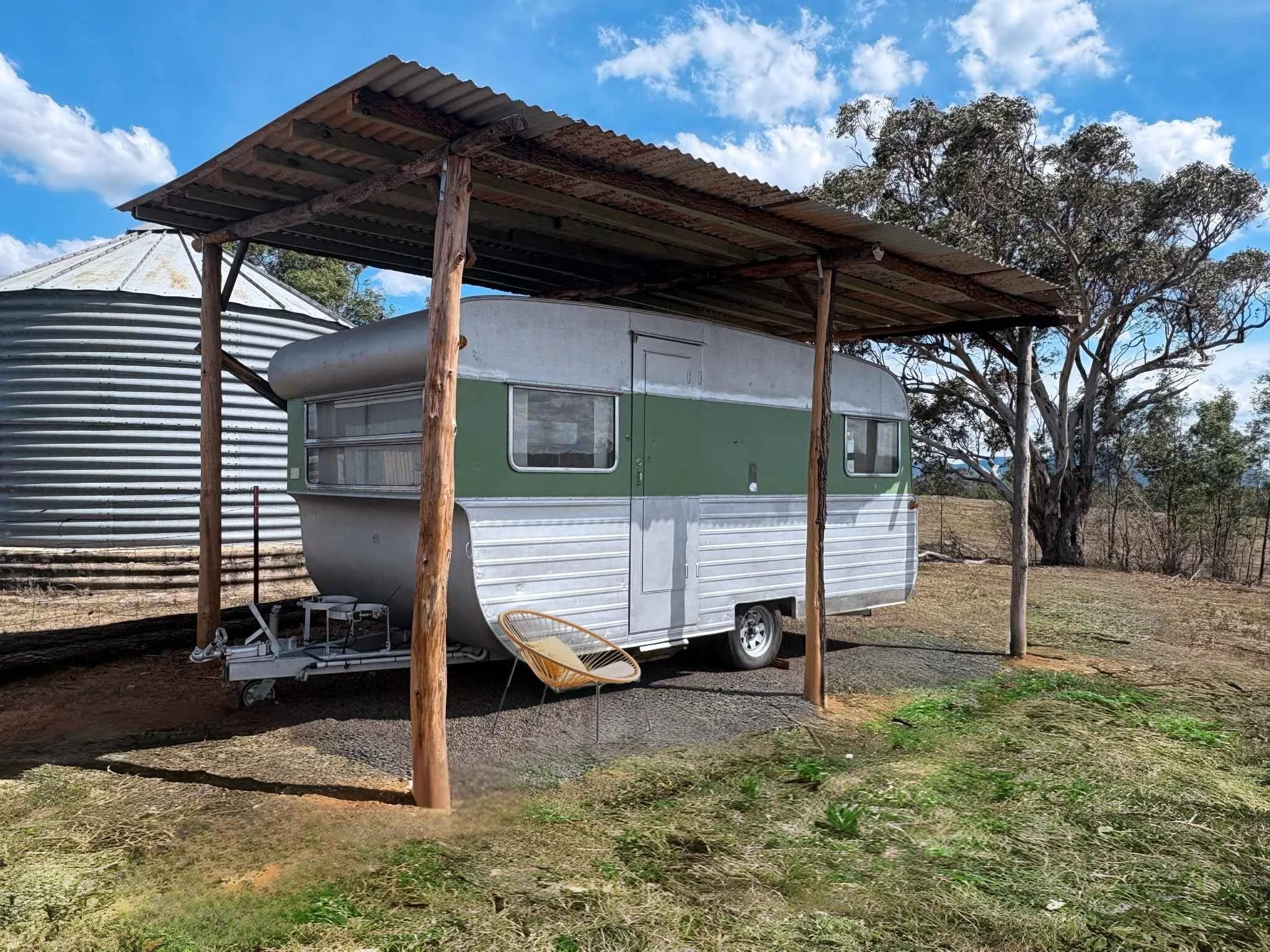 Restored vintage caravan under shelter with chair in Capertee Valley.jpg