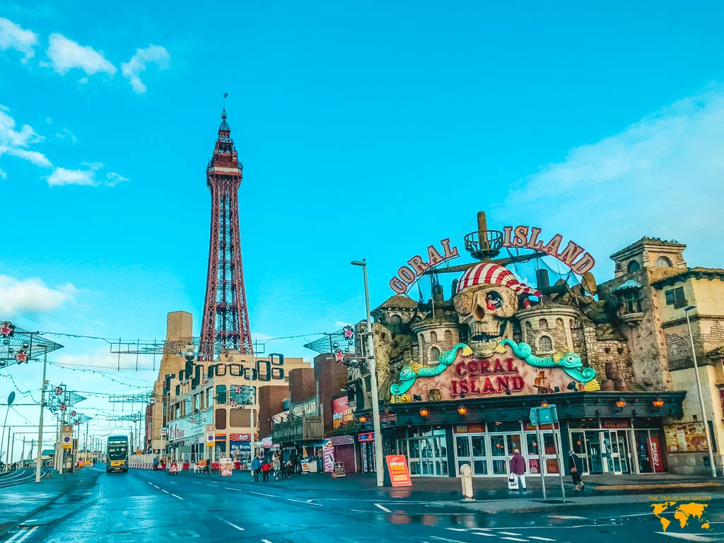 Coral Island arcade front with Blackpool tower behind it early in the morning in Blackpool.