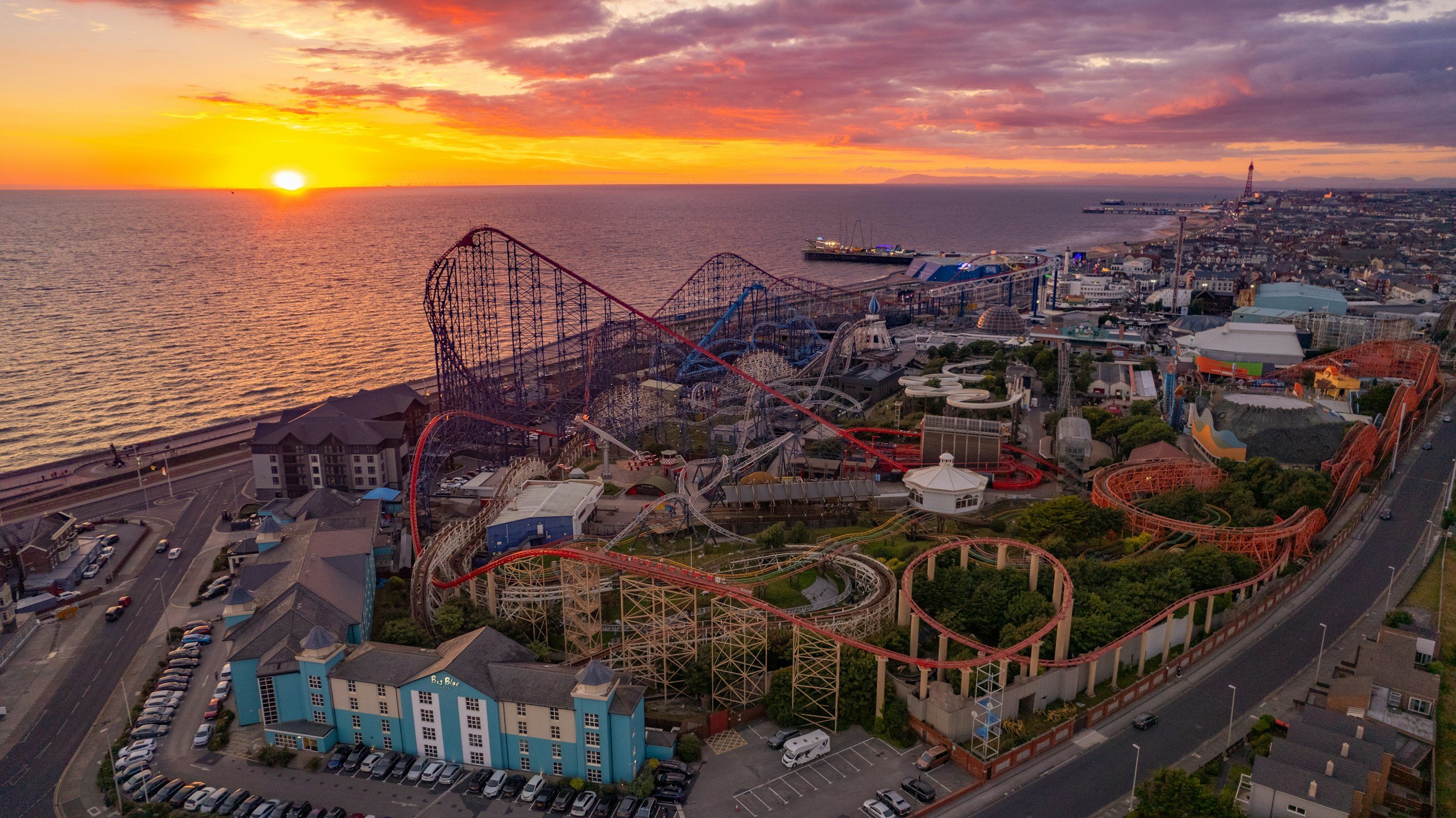 The Big One roller coaster at the Blackpool Pleasure Beach at sunset from above on a clear day.