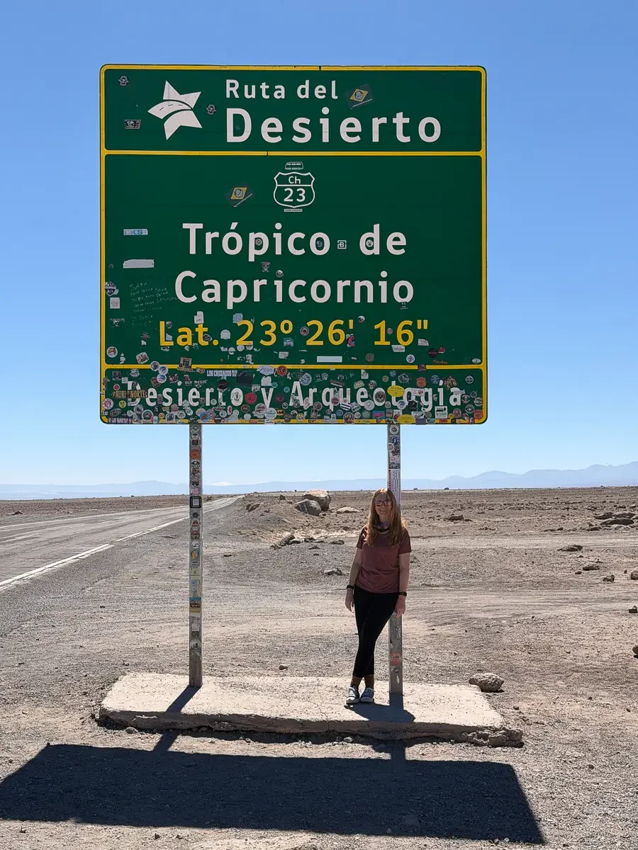 Large green Trópico de Capricornio road sign marking latitude 23°26'16" on Route 23 in the Atacama Desert, Chile