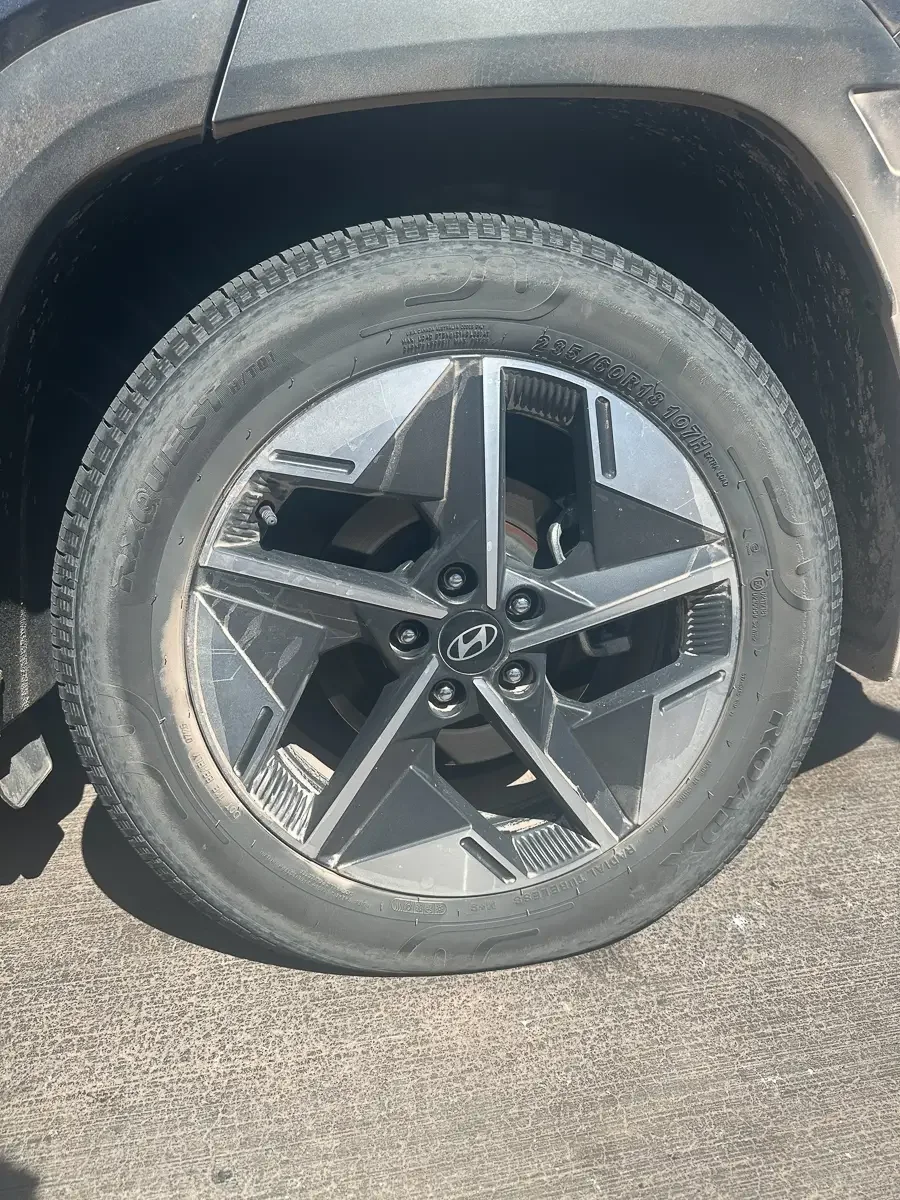 Close-up of a rental car tire with low pressure, photographed roadside in the Atacama Desert, Chile