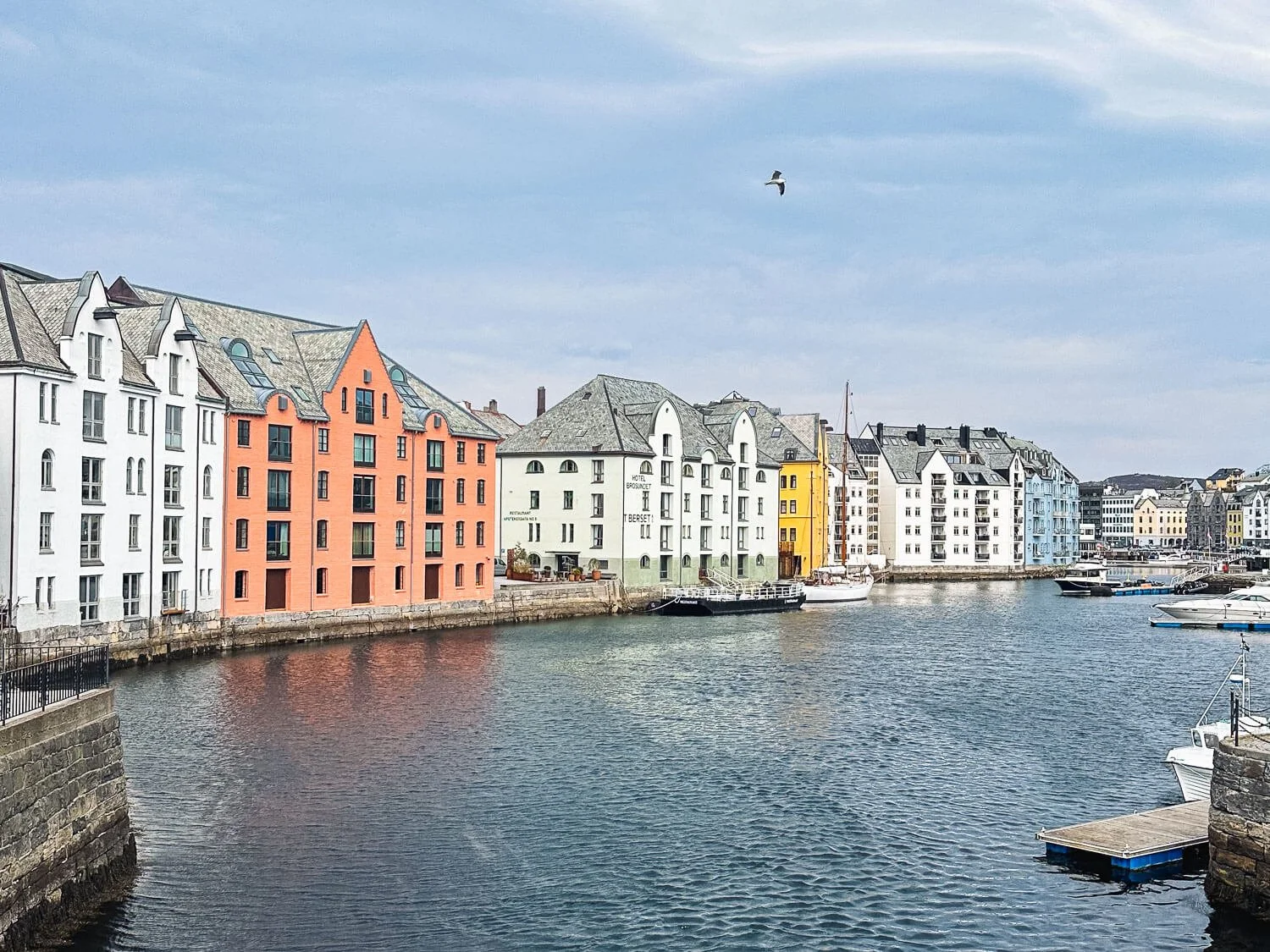 Pastel Art Nouveau buildings along the Alesund harbor waterfront Norway
